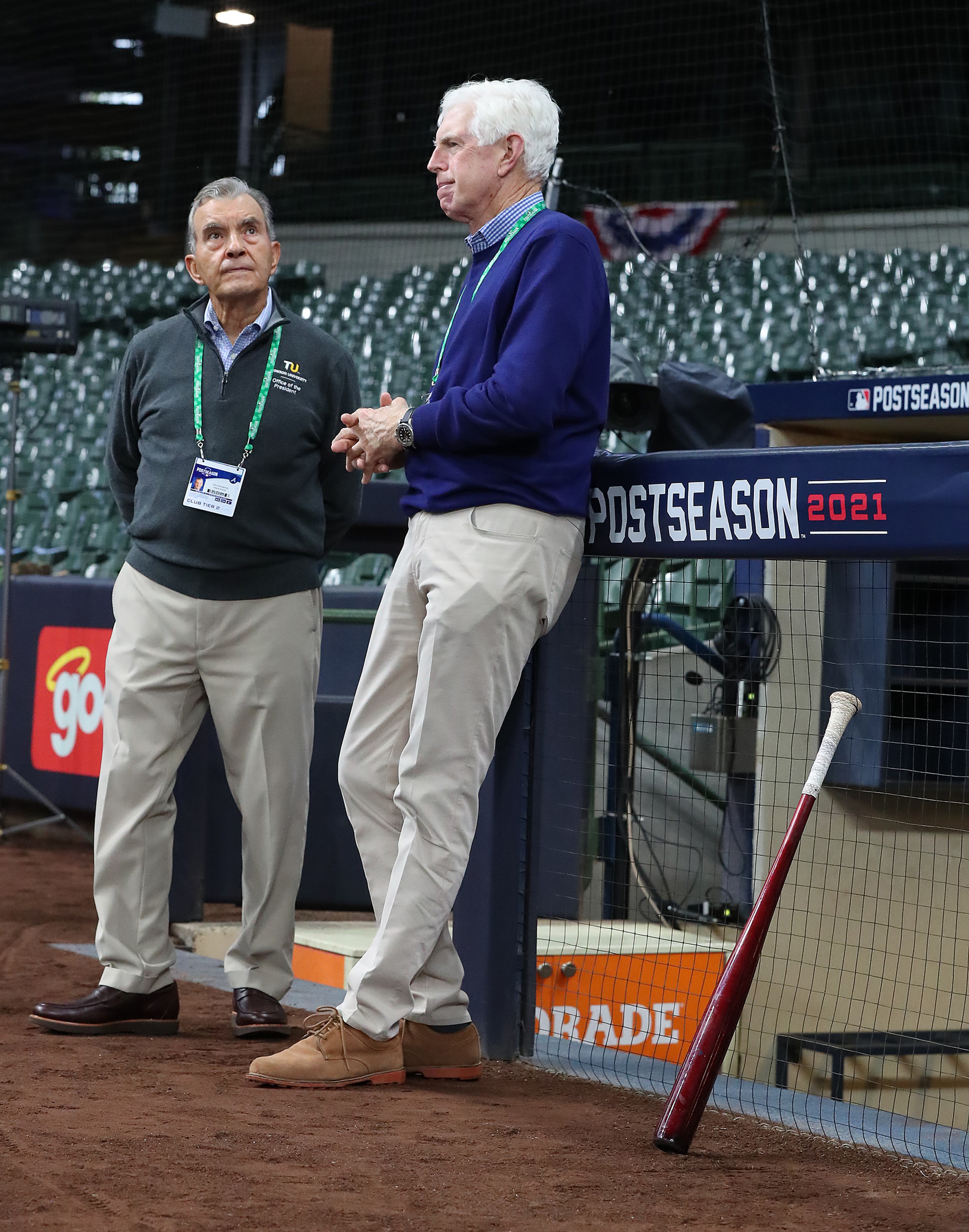 Braves Vice Chairman Emeritus John Schuerholz (left) and Chiariman & CEO Terry McGuirk (right) watch team practice at American Family Field. “Curtis Compton / Curtis.Compton@ajc.com”