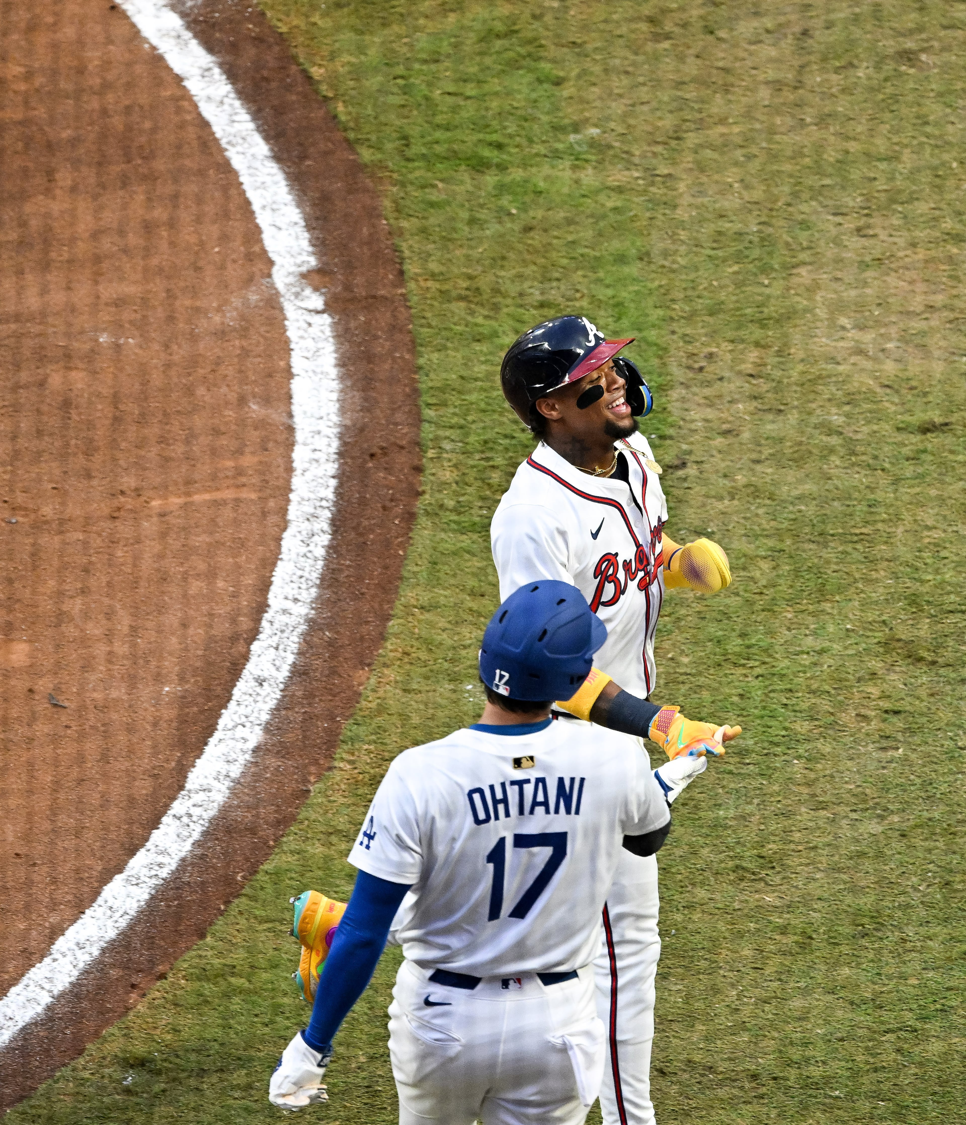 The National League's Ronald Acuña Jr. of the Atlanta Braves celebrates with designated hitter Shohei Ohtani of the Los Angeles Dodgers after scoring a run against the American League during the first inning of the MLB All-Star Game at Truist Park in Atlanta on Tuesday, July 15, 2025. (Hyosub Shin/AJC)