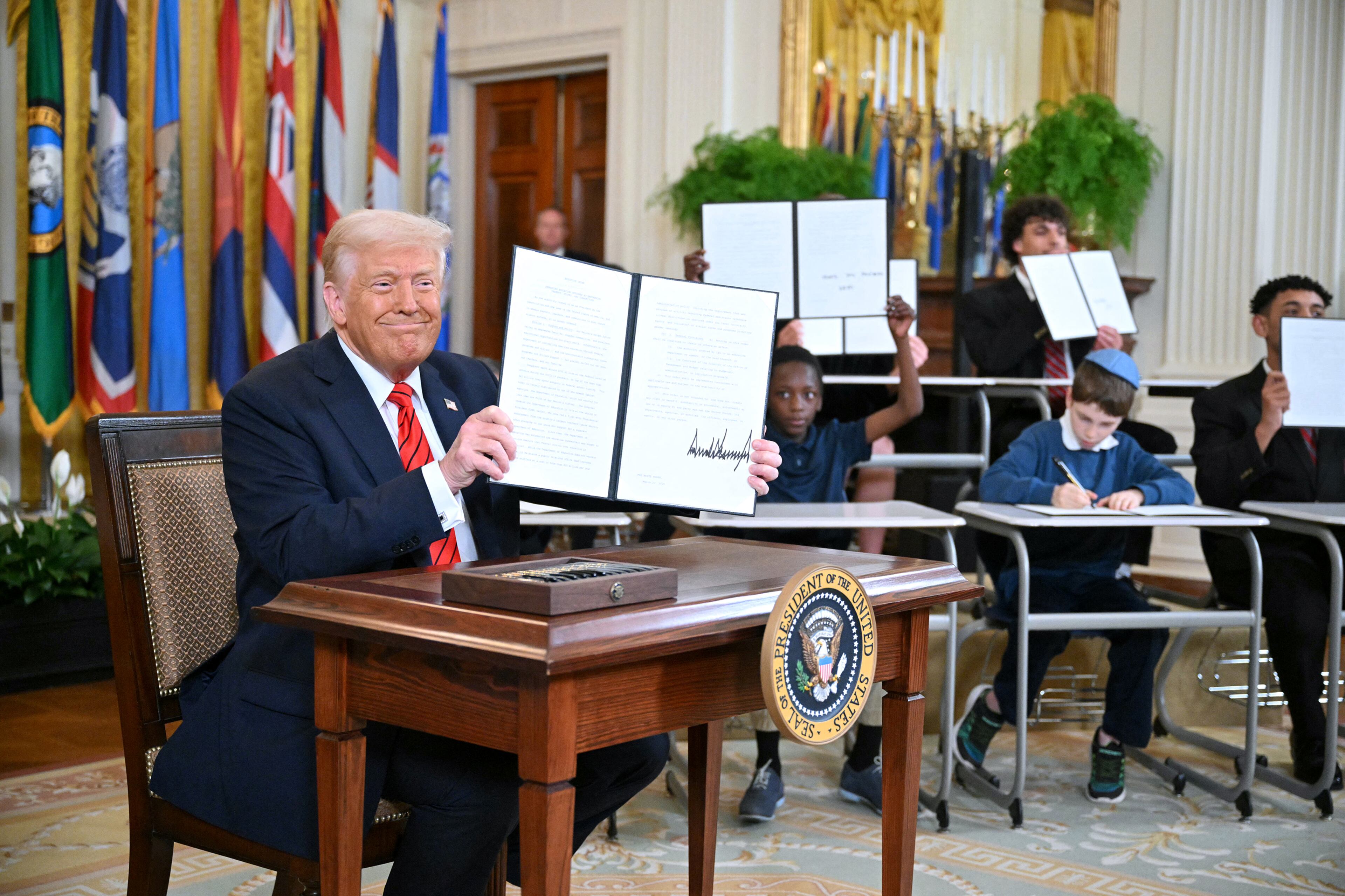 President Donald Trump holds an executive order to start dismantling the Department of Education, after signing it in the East Room of the White house in Washington, D.C., March 20, 2025. (Mandel Ngan/AFP/Getty Images/TNS)