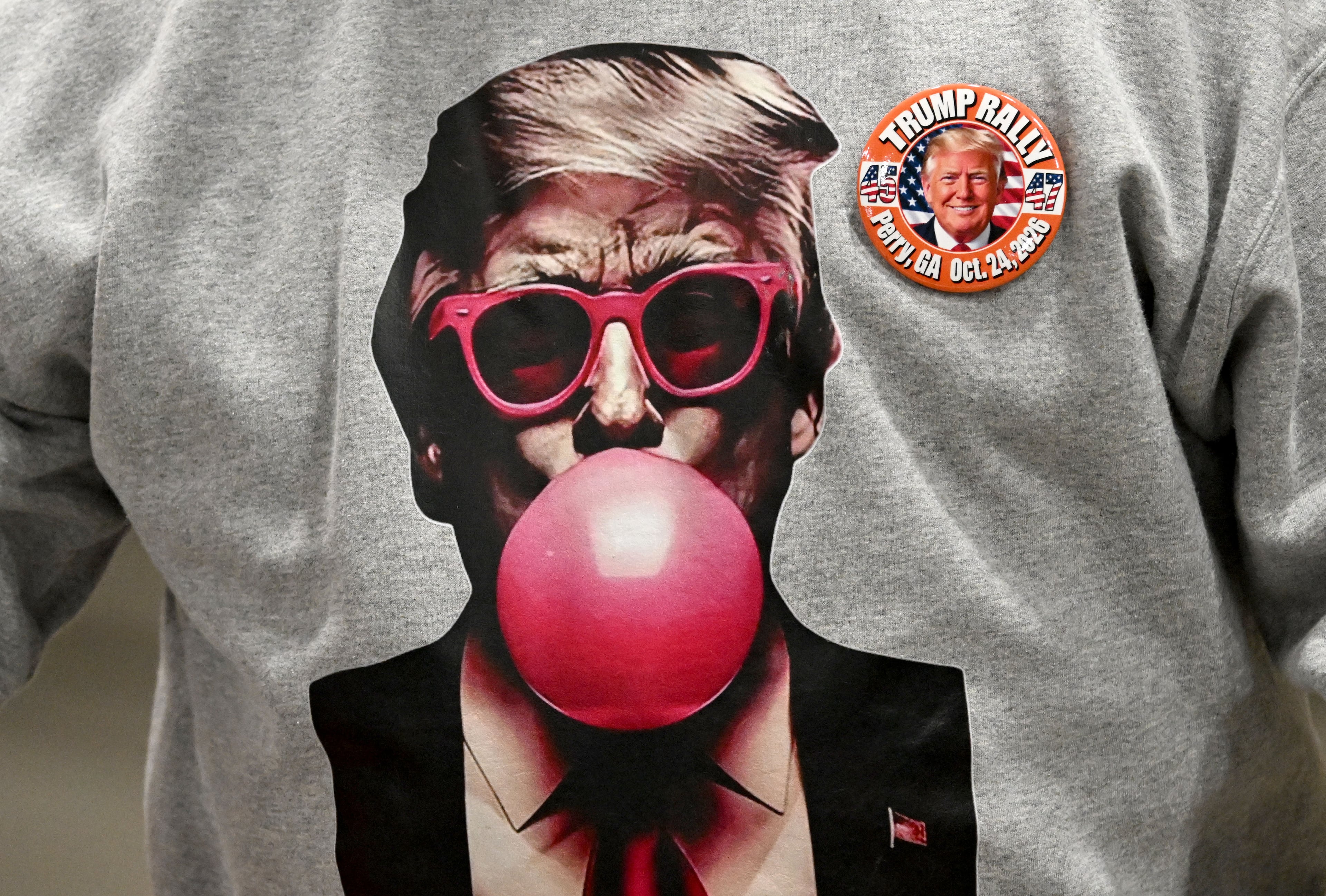 An attendee wearing a T-shirt supporting President Donald Trump is seen during a midterm campaign rally at Guardian Centers on Saturday, Oct. 24, 2026, in Perry. (Hyosub Shin/AJC)