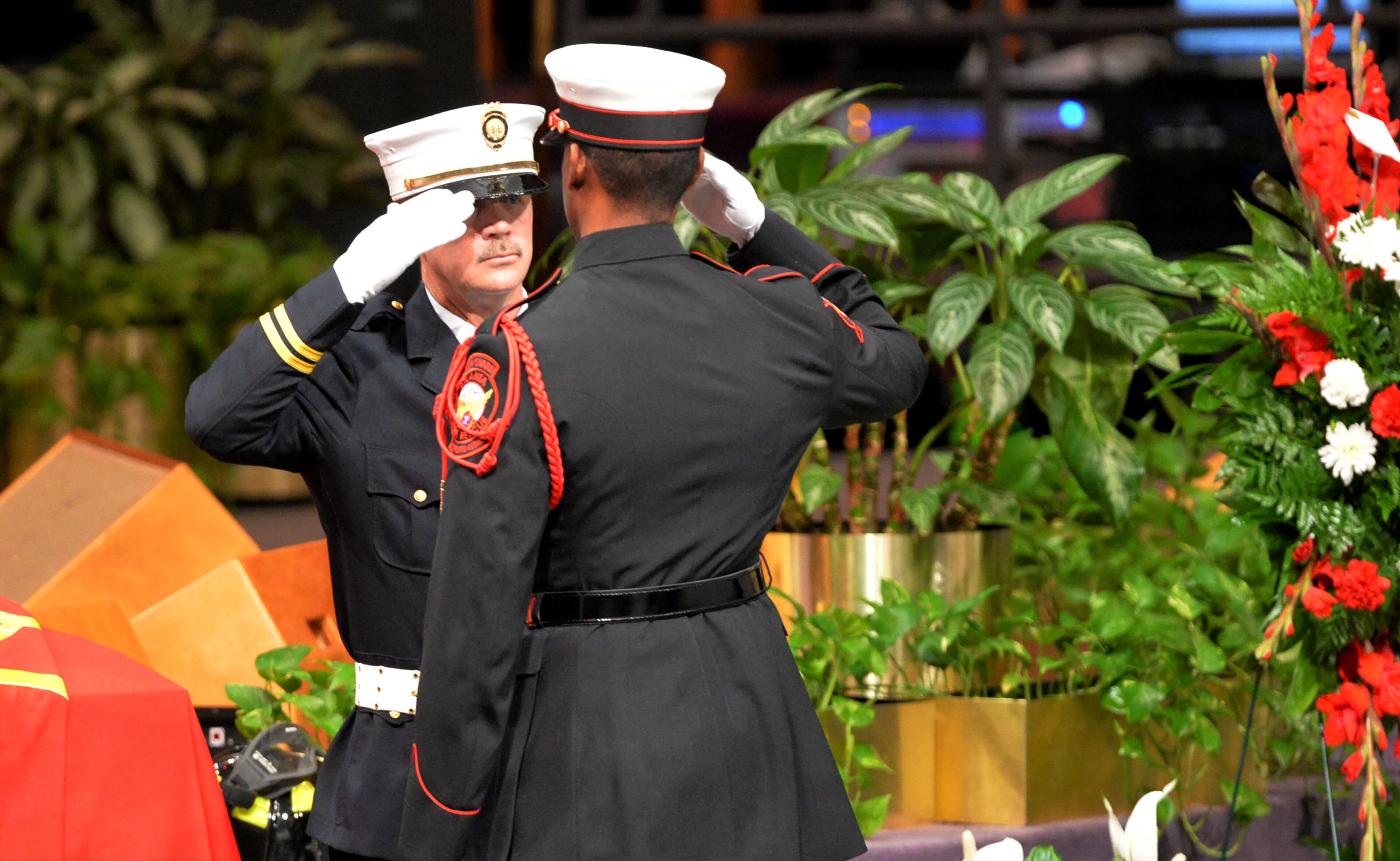 APRIL 18, 2014 ATLANTA Honor Guard members switch posts during the service. Firefighters from Marietta, Dekalb and Gwinnett joined with Atlanta Fire Rescue officials and firefighters, family and friends during the funeral of AFRD firefighter Jermaine Hall at New Birth Missionary Baptist Church, Friday, April 18, 2014. Firefighter Hall, 24, died as the result of a brain aneurysm. He was the second AFRD firefighter to die in the last week. Memorial funds for both Hall and Sgt Frank Guinn, who was killed in an accident in New Orleans, have been set up at Wells Fargo branches. Donations can be made to any Wells Fargo branch in the names of Frank Guinn Memorial Fund Jermaine Hall Memorial Fund. KENT D. JOHNSON/KDJOHNSON@AJC.COM