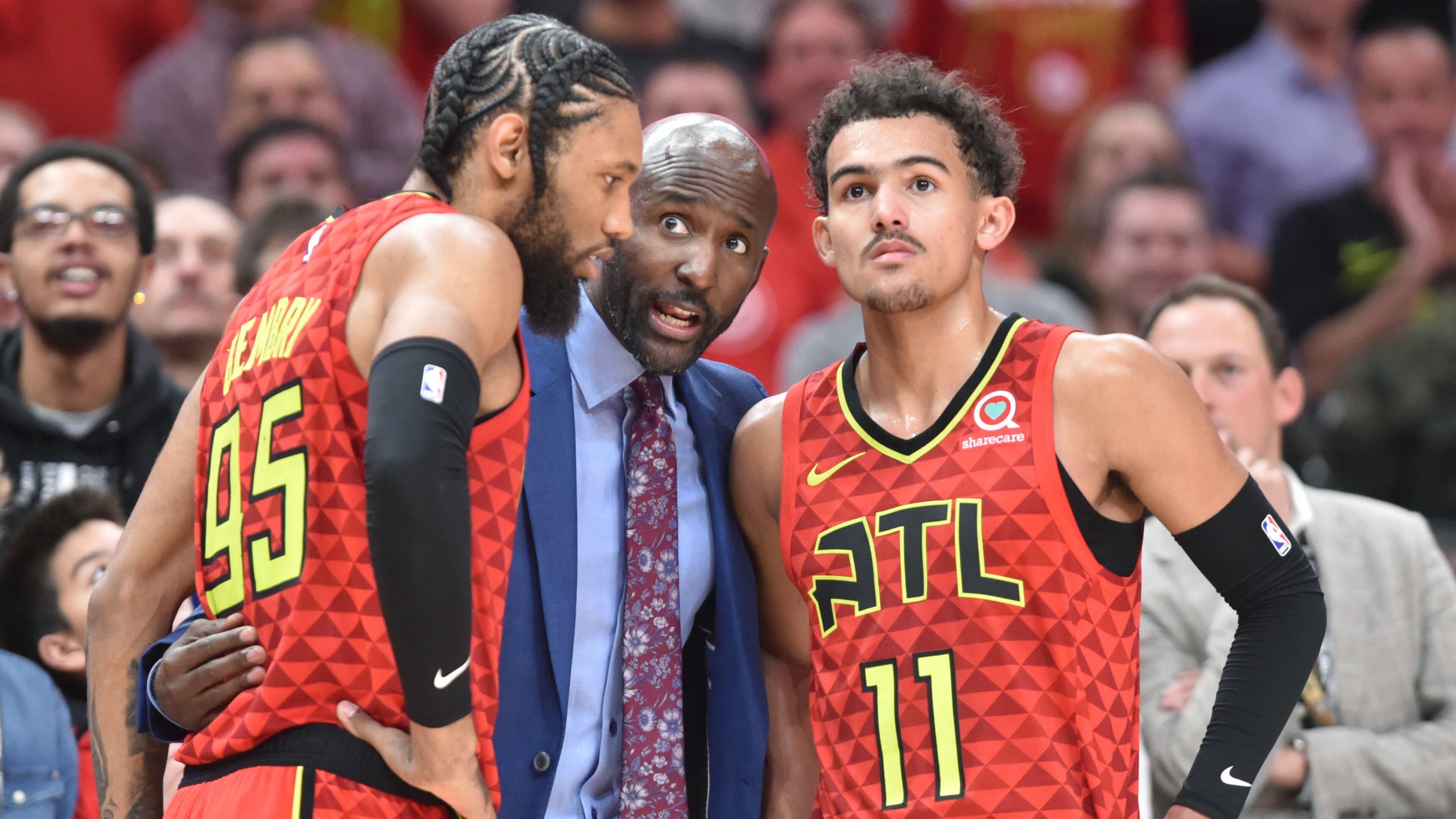 Atlanta Hawks head coach Lloyd Pierce instruct Atlanta Hawks forward DeAndre' Bembry (95) and Atlanta Hawks guard Trae Young (11) during the second half of the home opener in an NBA basketball game at State Farm Arena on Wednesday, October 24, 2018. HYOSUB SHIN / HSHIN@AJC.COM