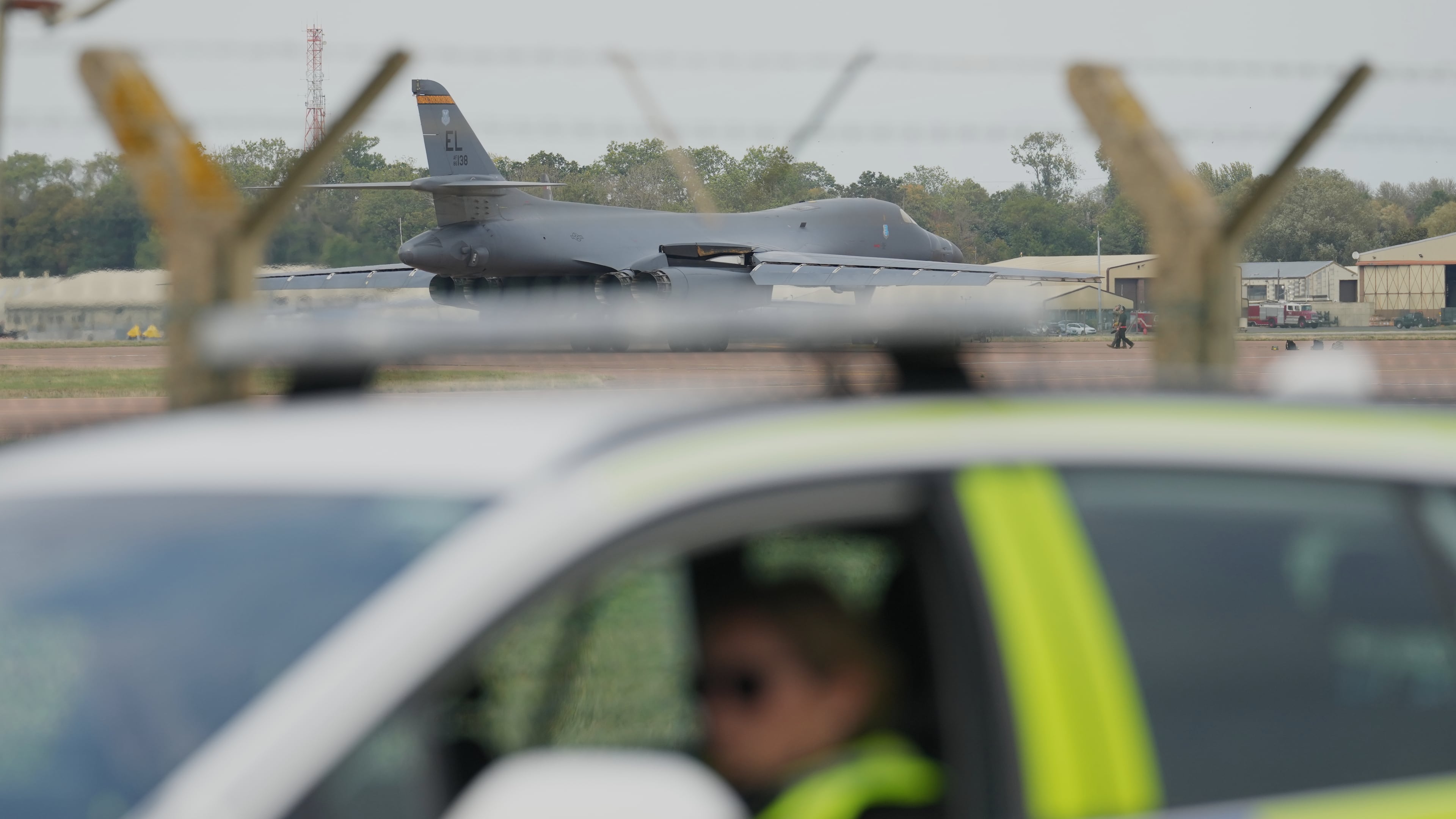 FILE - A B1 bomber prepares to take off as police officers guard a checkpoint near RAF Fairford air base, in Fairford, England, Tuesday, Sept. 29, 2026. (AP Photo/Alastair Grant, File)
