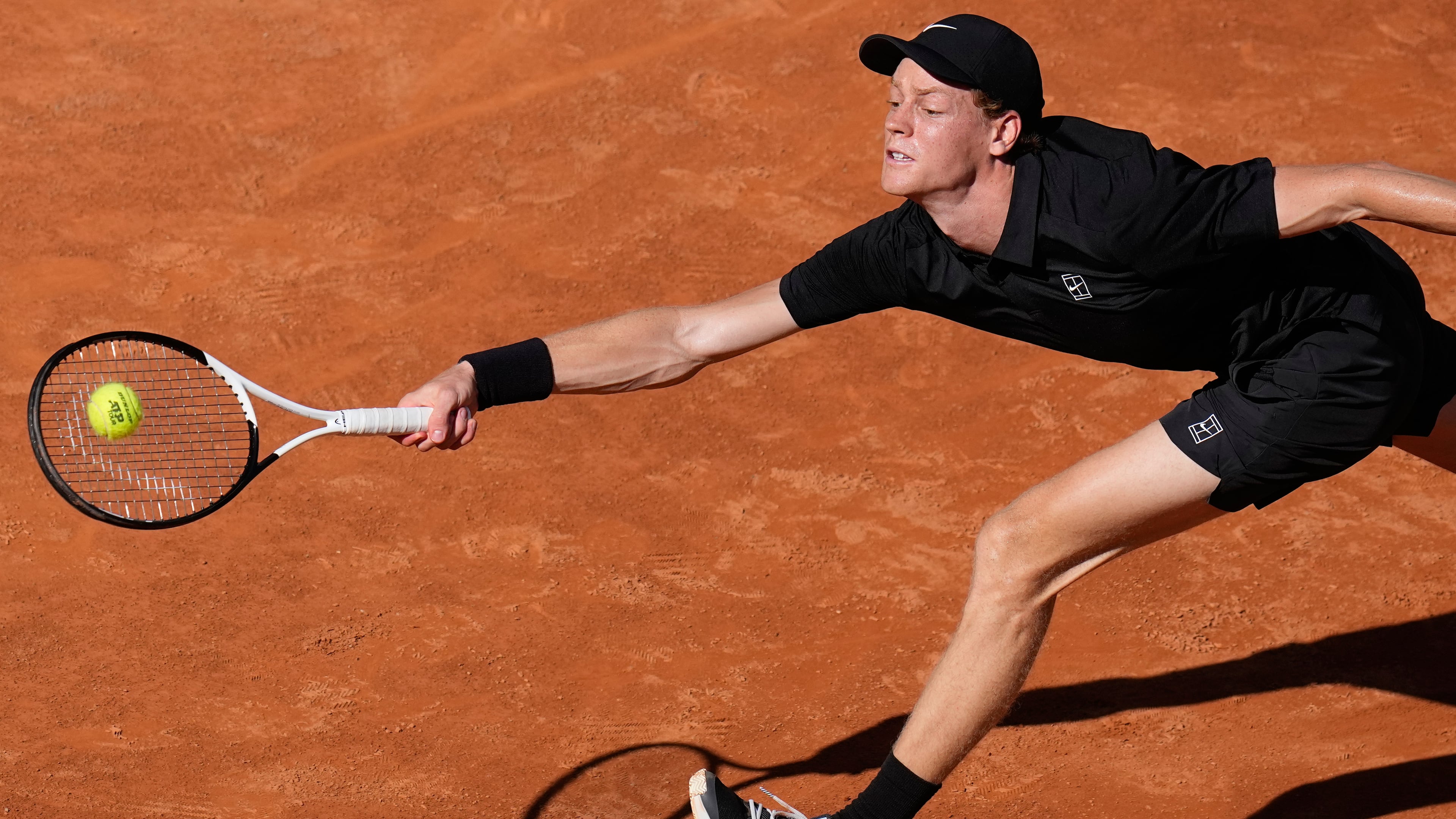 Italy's Jannik Sinner stretches to return the ball to Australia's Alexei Popyrin, during their match at the Italian Open tennis tournament in Rome, Monday, May 11, 2026. (AP Photo/Alessandra Tarantino)