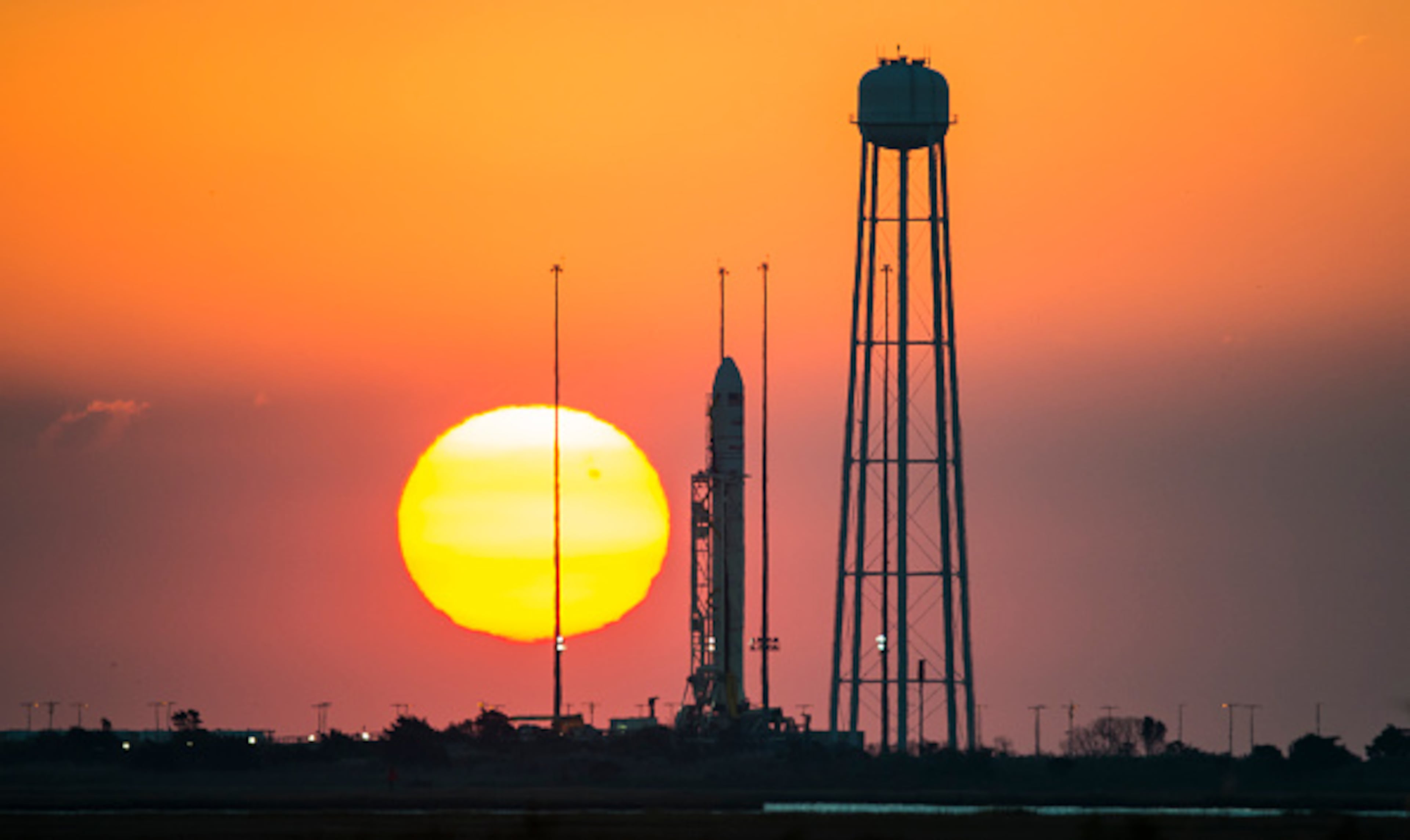 WALLOPS ISLAND, VA - OCTOBER 25: In this handout from NASA, the Orbital Sciences Corporation Antares rocket, with the Cygnus spacecraft onboard, sits on launch Pad-0A during sunrise October 25, 2014, at NASA's Wallops Flight Facility, Wallops Island, Virginia. The Antares will launch with the Cygnus filled with over 5,000 pounds of supplies for the International Space Station (ISS), including science experiments, experiment hardware, spare parts, and crew provisions. The Orbital-3 mission is Orbital Sciences' third contracted cargo delivery flight to the space station for NASA and will launch on October 27, 2014. Photo Credit: (Photo by NASA/Joel Kowsky via Getty Images)