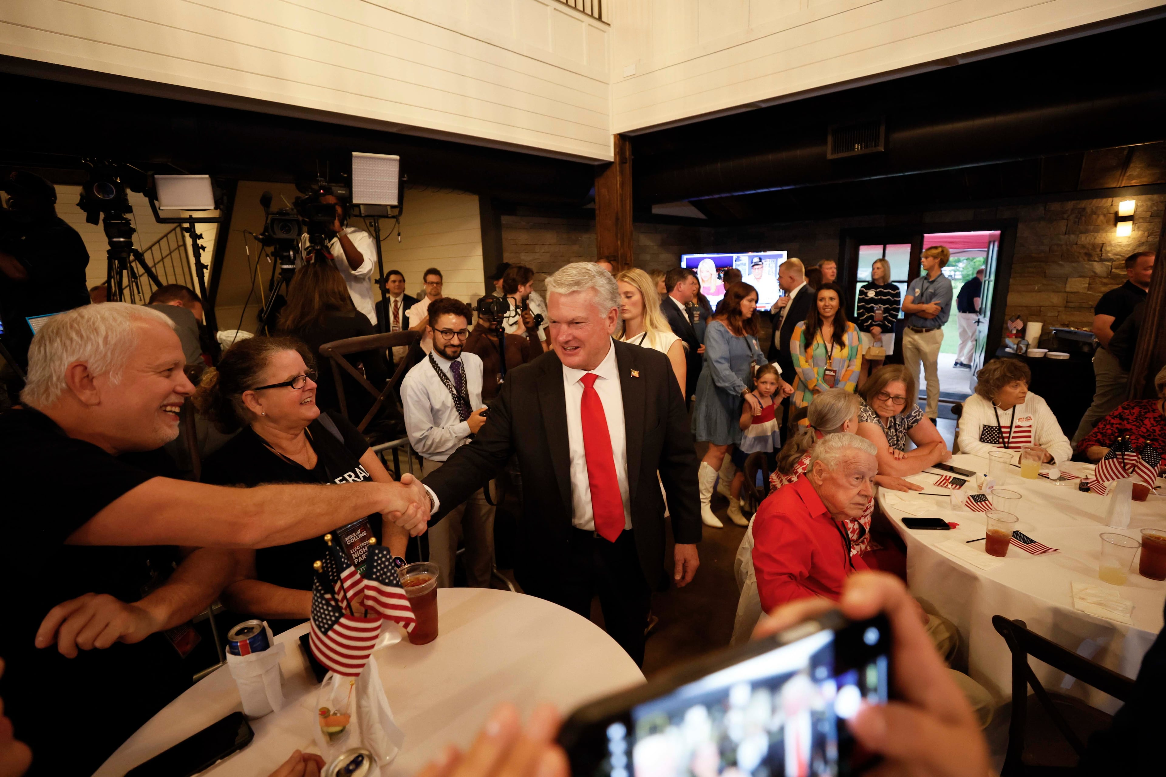 U.S. Rep. Mike Collins is welcomed by supporters as he arrives at his runoff election watch party at Seven Oaks Manor in Jackson, Georgia, on Tuesday, June 16, 2026. (Miguel Martinez/AJC)