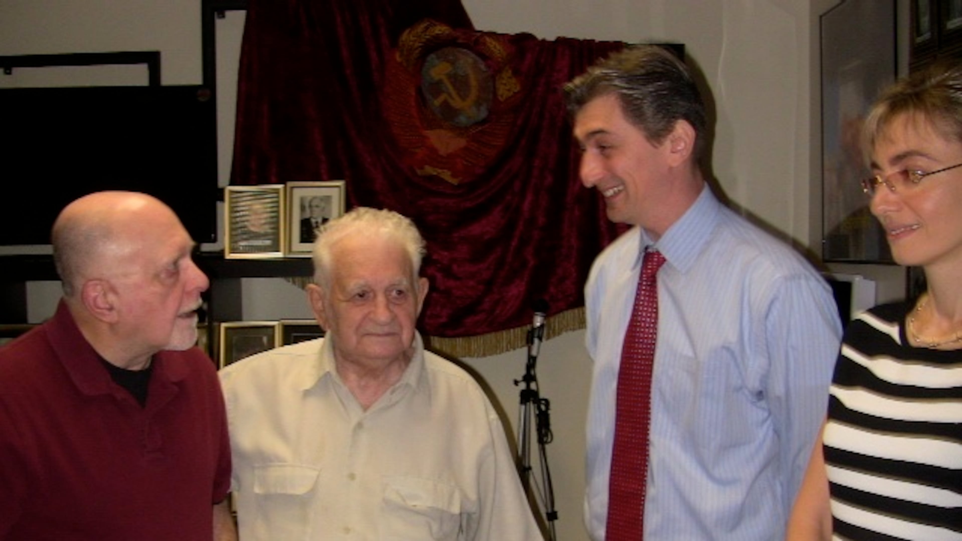John Kovach, adjutant of the Atlanta World War II Roundtable, chats with Col. Khanon Zaratsky of the former Soviet army and Victor and Julia Vaysman, both from the former USSR, who provide space in their Sandy Springs building for meetings of the Museum of Camaraderie.