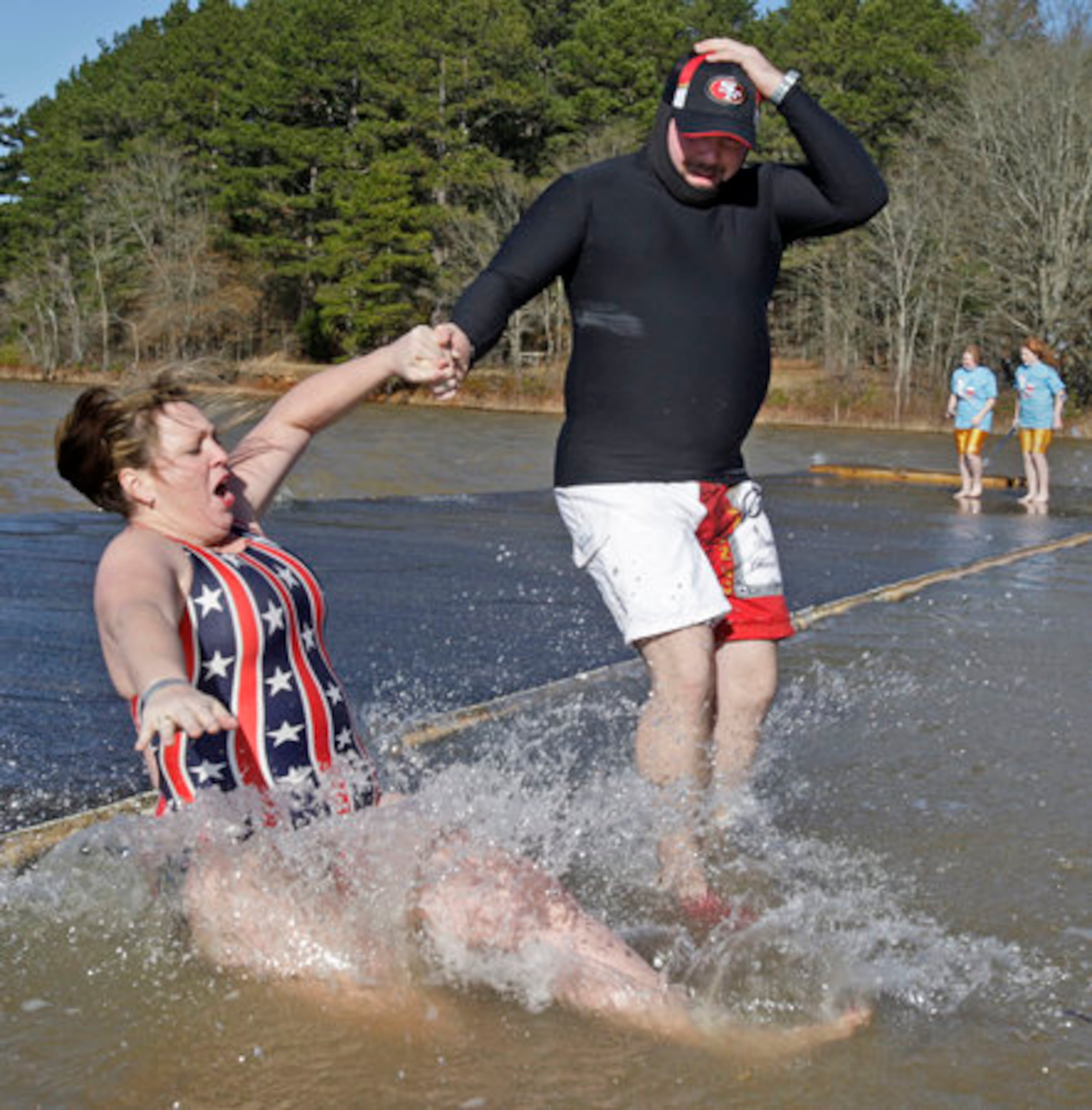 Phalynn Powers seems shocked at just how cold the water is, while David Fleming seems to have come prepared. Is that a wet suit?