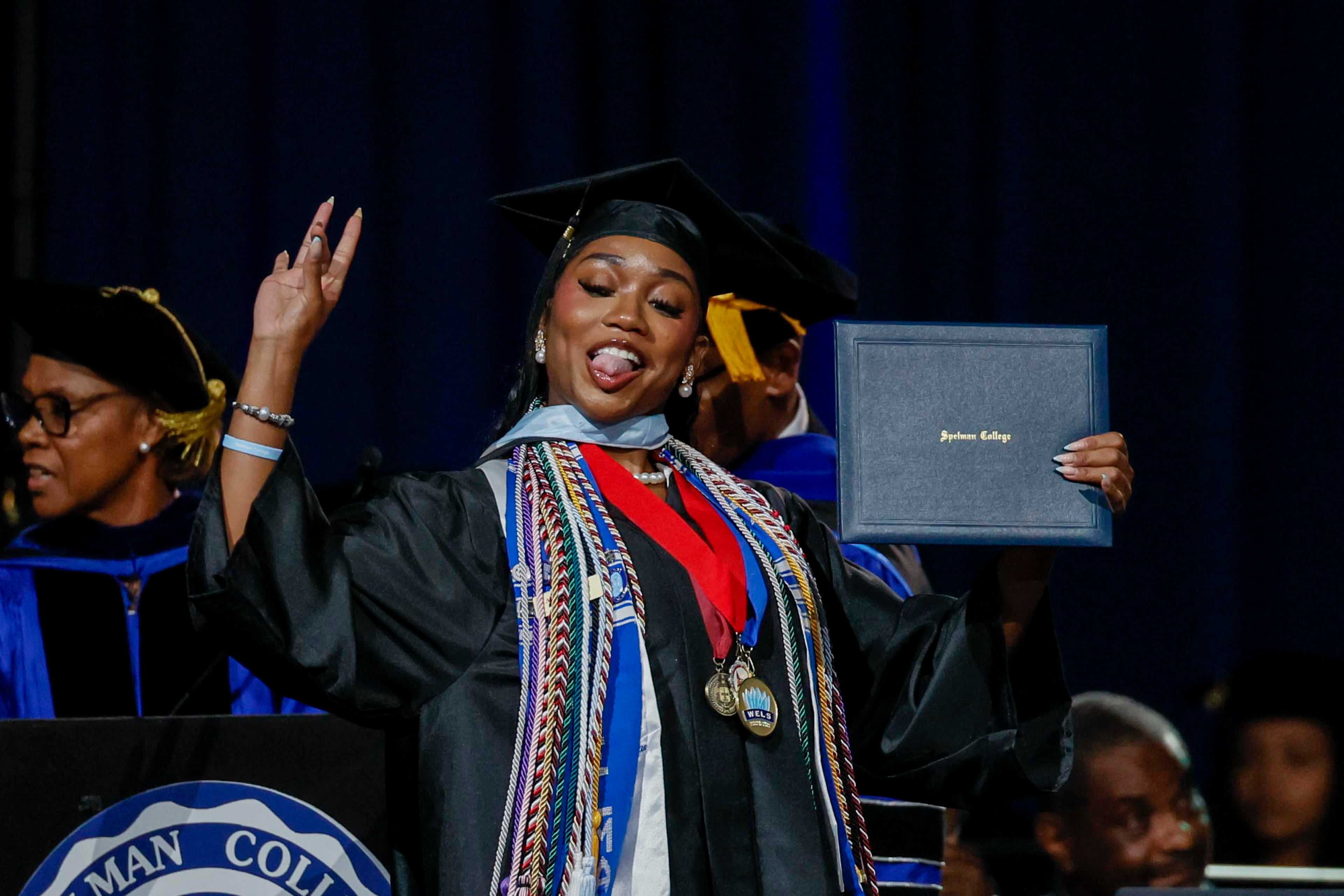 A graduate reacts after receiving her diploma during the Spelman College Commencement at the Georgia International Convention Center in College Park on Sunday, May 17, 2026. (Miguel Martinez/AJC)
