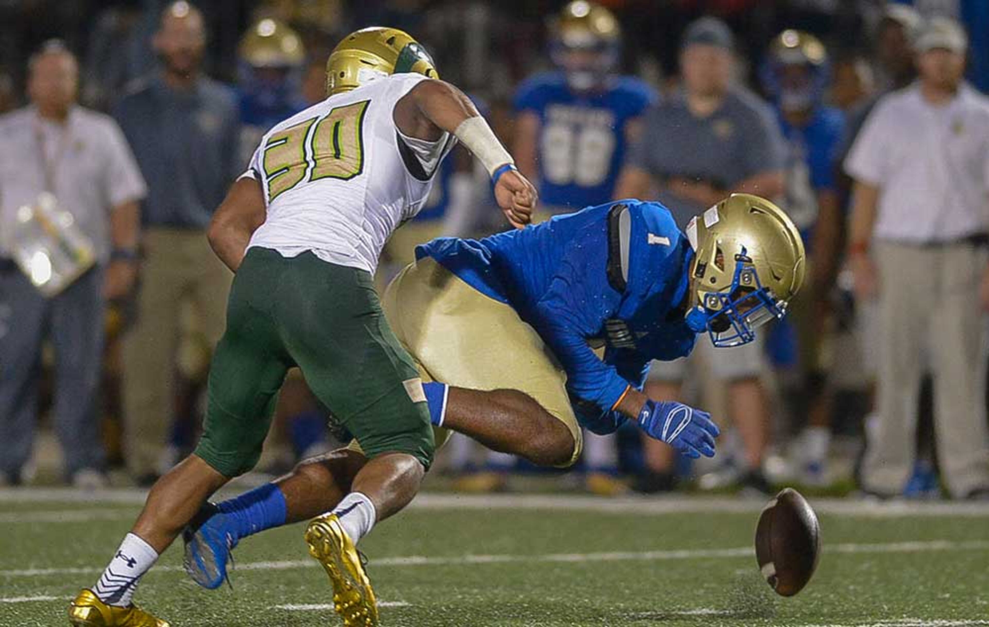 McEachern senior RB Quay Holmes (1) and Grayson Malik Murphy (30) scramble for a loose ball in the second half of Friday's game.