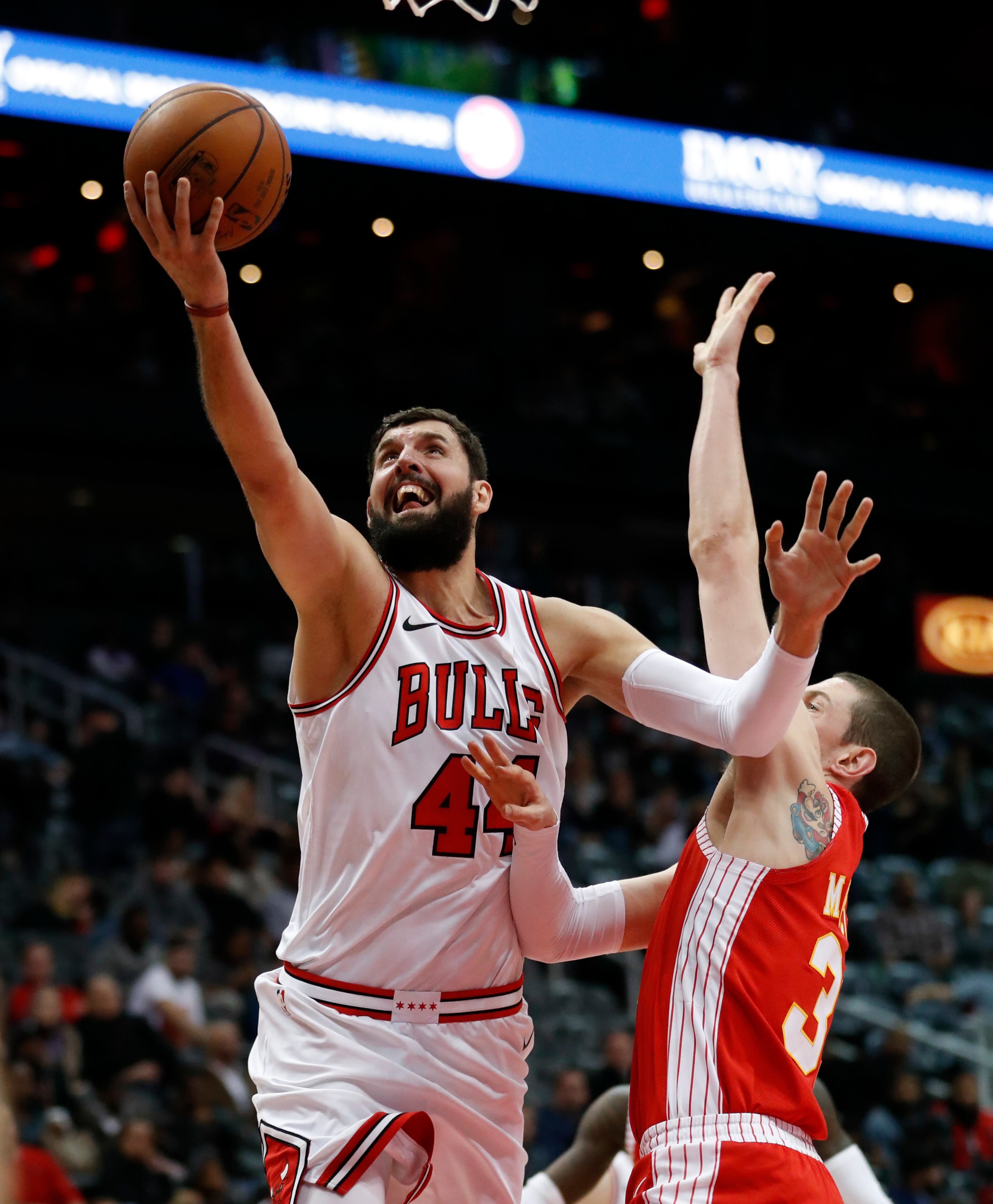 Chicago Bulls forward Nikola Mirotic (44) shoots as Atlanta Hawks forward Mike Muscala (31) defends during the second half of an NBA basketball game Saturday, Jan. 20, 2018, in Atlanta. Chicago won 113-97. (AP Photo/John Bazemore)
