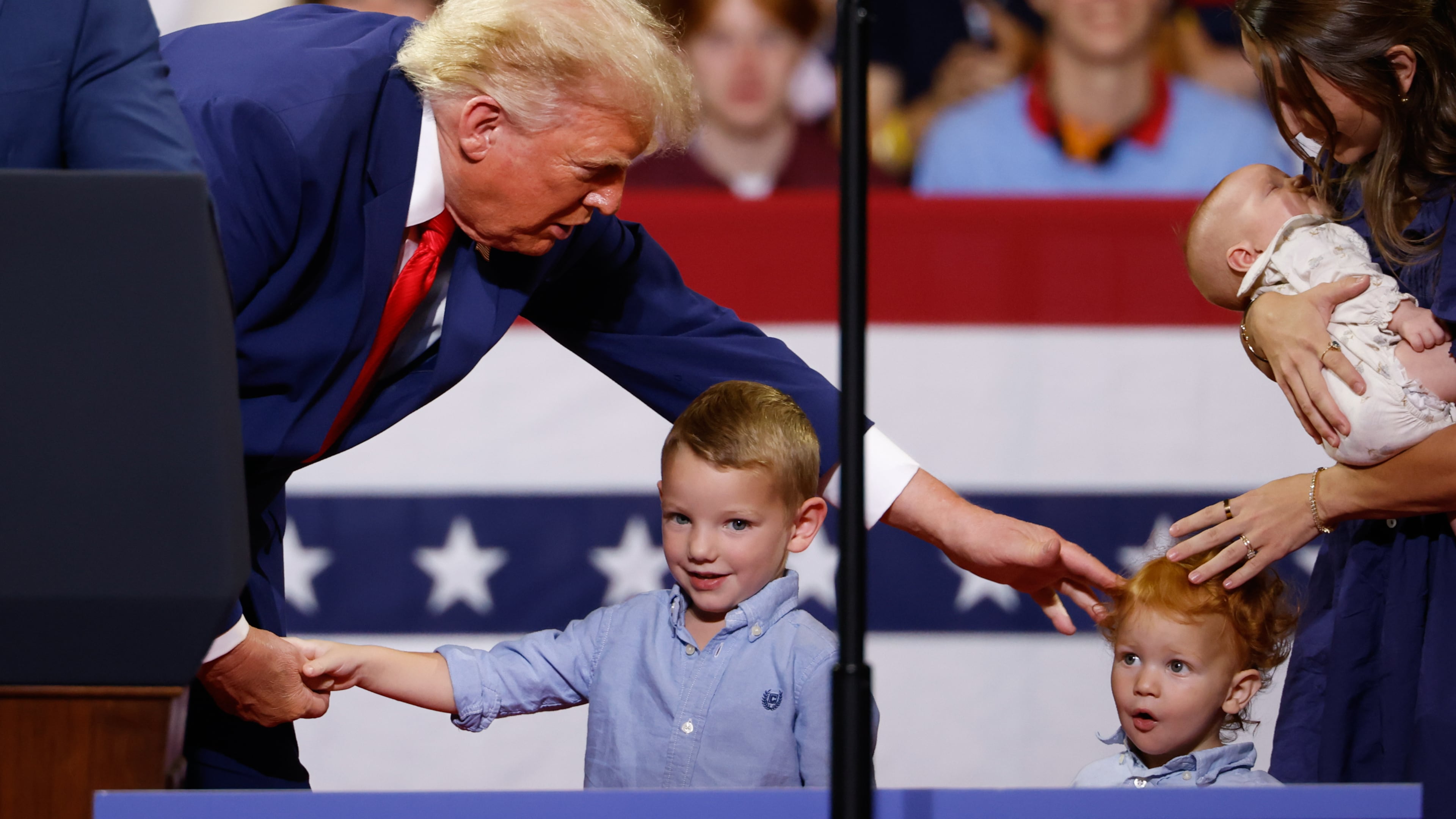 President Donald Trump greets members of the Loden family, who signed up for Trump Accounts, during his rally at Wheeler High School on Wednesday, July 22, 2026, in Marietta. (Arvin Temkar/AJC)