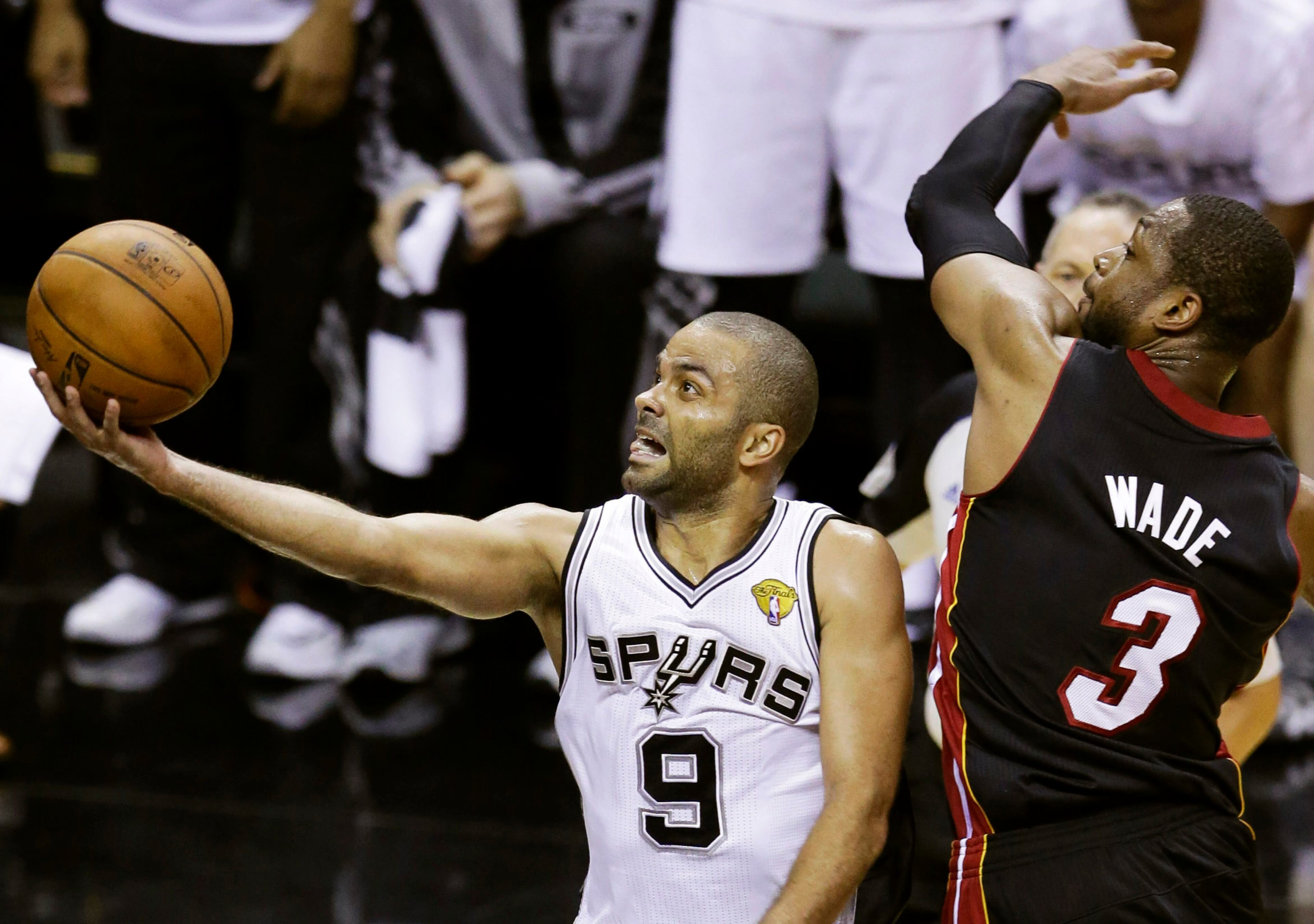 San Antonio Spurs guard Tony Parker (9) shoots against Miami Heat guard Dwyane Wade (3) during the first half in Game 2 of the NBA basketball finals on Sunday, June 8, 2014, in San Antonio. (AP Photo/Tony Gutierrez)