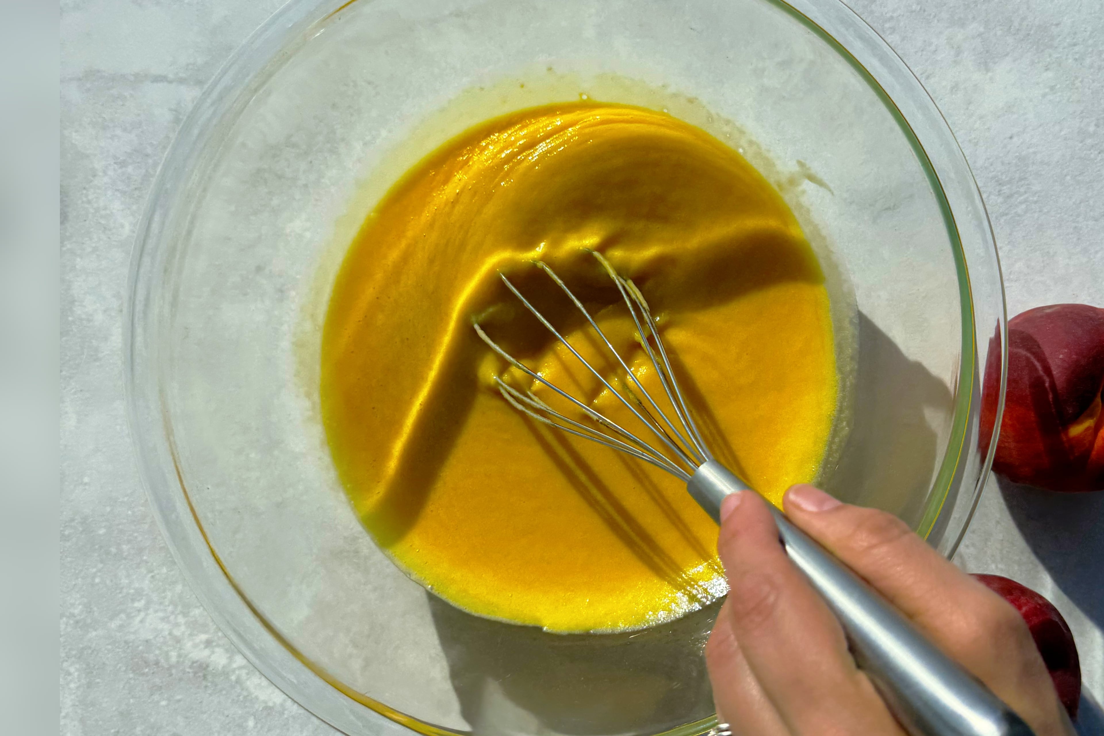Whisk peach curd constantly until it thickens enough to coat the back of. a spoon. (Monti Carlo/AJC)