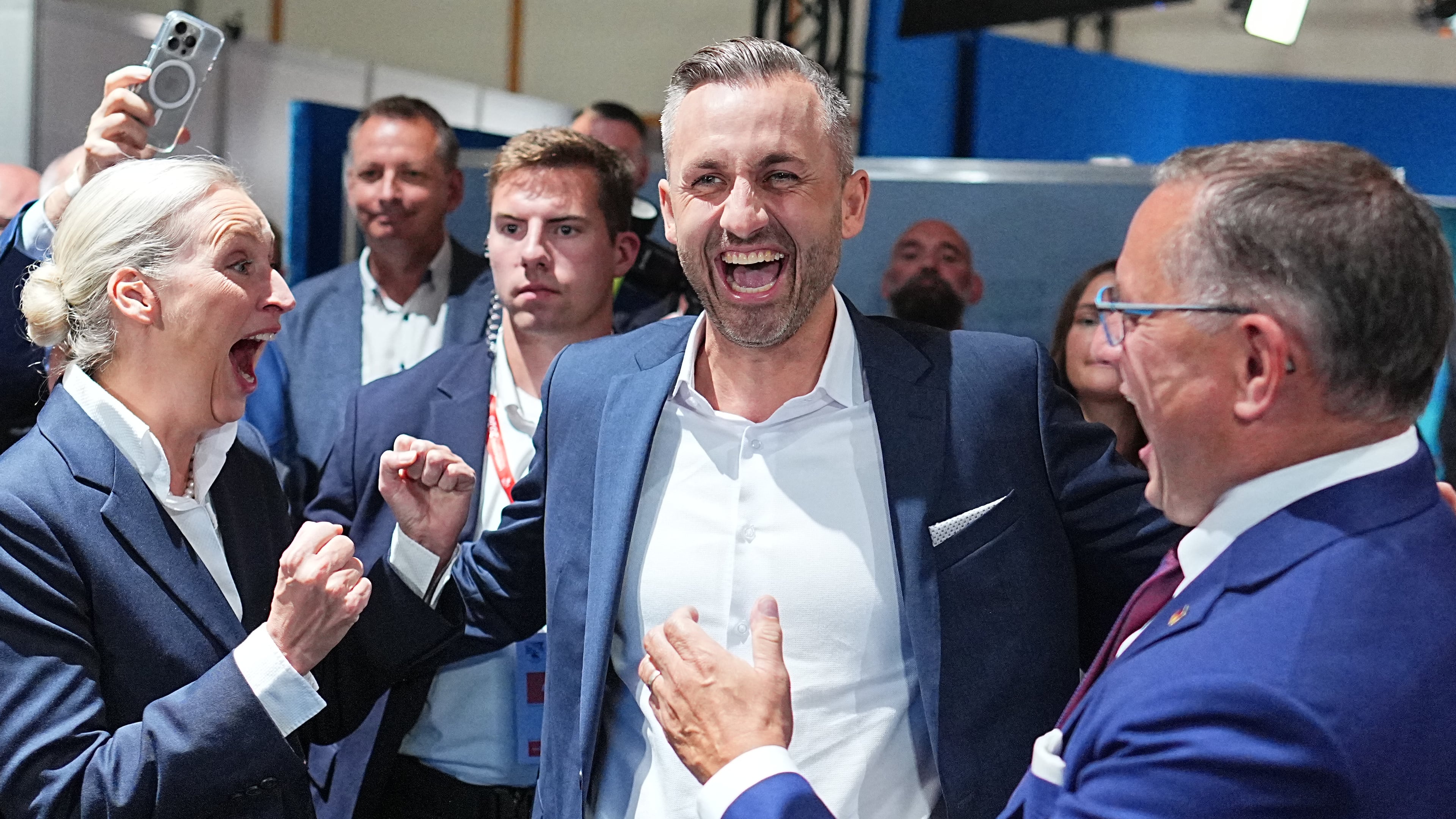 Ulrich Siegmund, center, lead candidate and co-chair of the AfD state parliamentary group in Saxony-Anhalt, celebrates with Alice Weidel, federal chairwoman and co-chair of the AfD parliamentary group in the Bundestag, and Tino Chrupalla, federal chairman and co-chair of the AfD parliamentary group in the Bundestag, after the first results at an election party of the "Alternative for Germany" (AfD) after the Saxony-Anhalt state elections in Magdeburg, eastern Germany, Sunday, Sept. 6, 2026. (Michael Kappeler/dpa via AP)