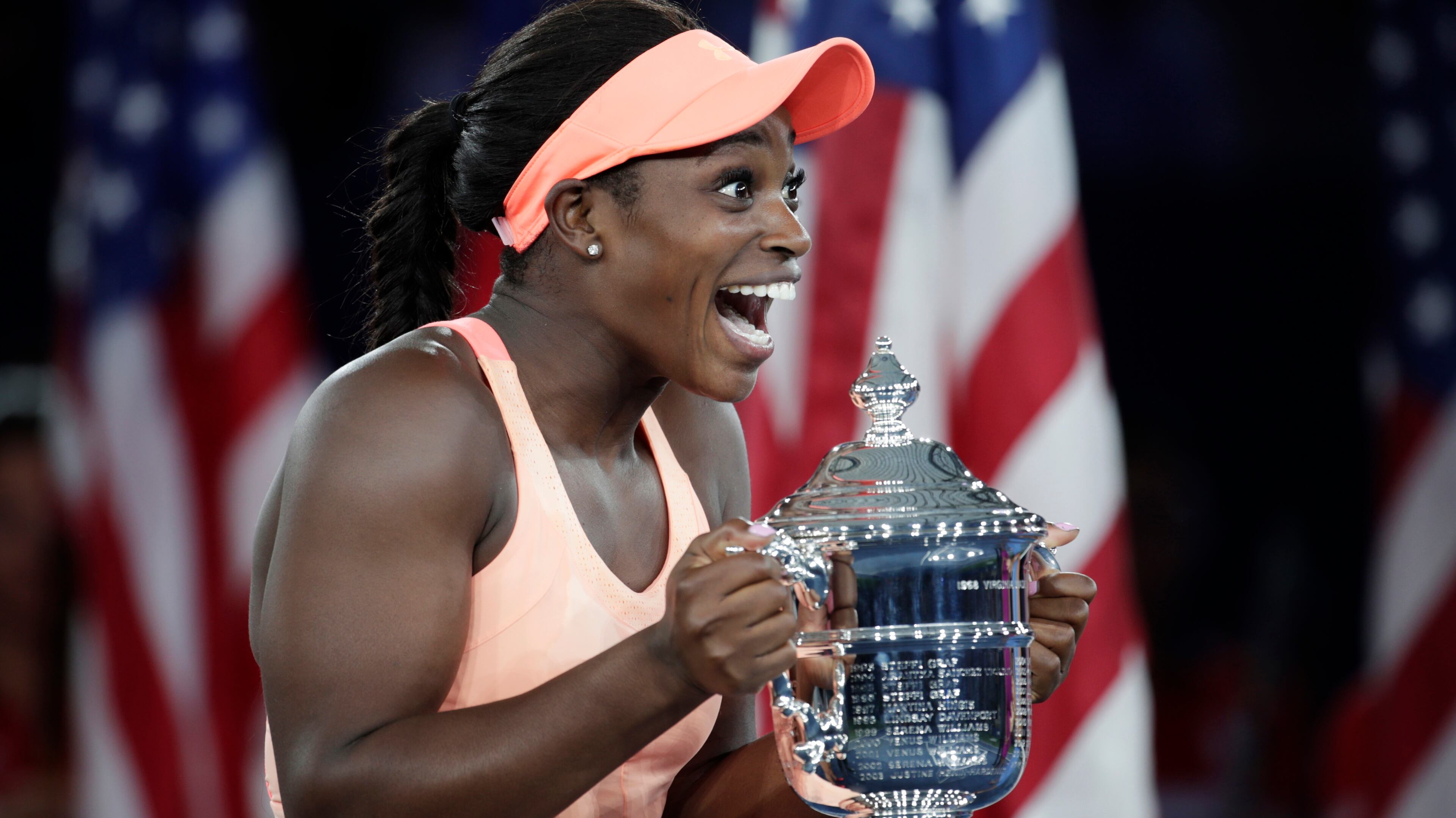 Sloane Stephens, of the United States, holds up the championship trophy after beating Madison Keys, of the United States, in the women's singles final of the U.S. Open tennis tournament, Saturday, Sept. 9, 2017, in New York. (AP Photo/Julio Cortez)
