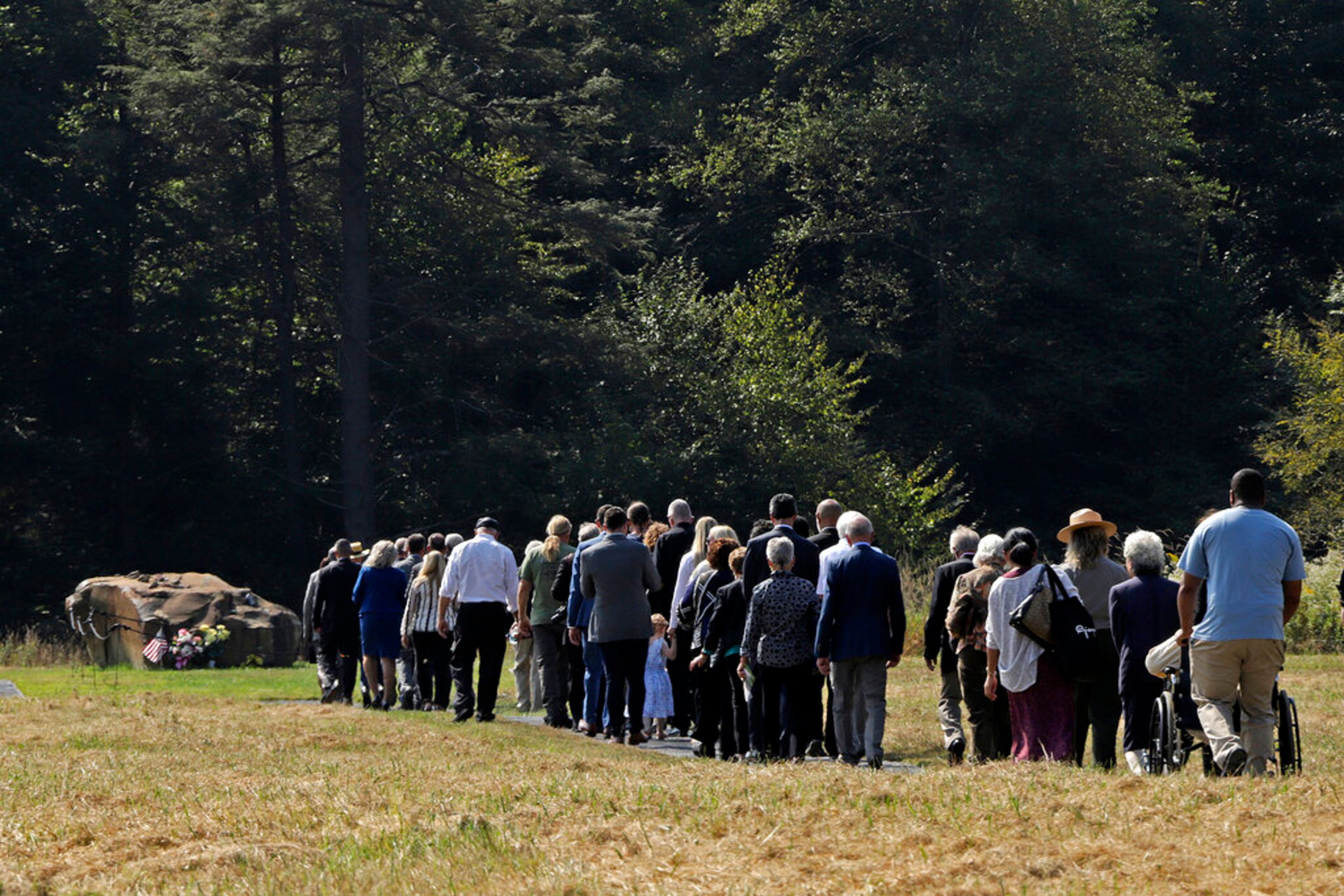 Vice President Mike Pence and second lady Karen Pence, lead the Families of Flight 93 down a path to a 17-ton boulder that marks the crash site of United Flight 93 following the September 11th Flight 93 Memorial Service at the Flight 93 National Memorial in Shanksville, Pa., Wednesday, Sept. 11, 2019, the 18th anniversary of the attacks. (AP Photo/Gene J. Puskar)