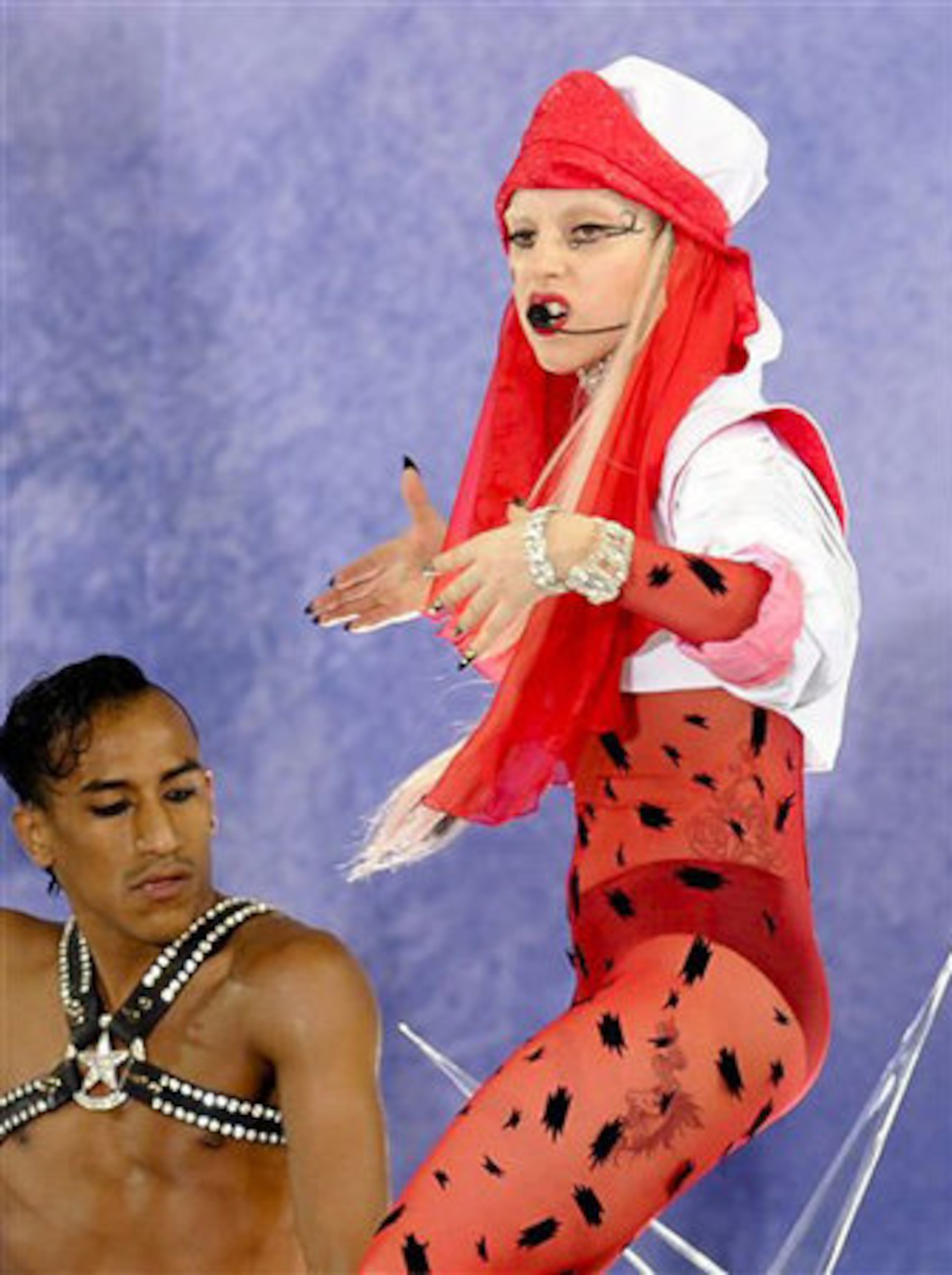 We're not sure what to call this outfit. Nurse from another planet? And is it just us, or does it look like cockroaches are crawling on her body stocking?