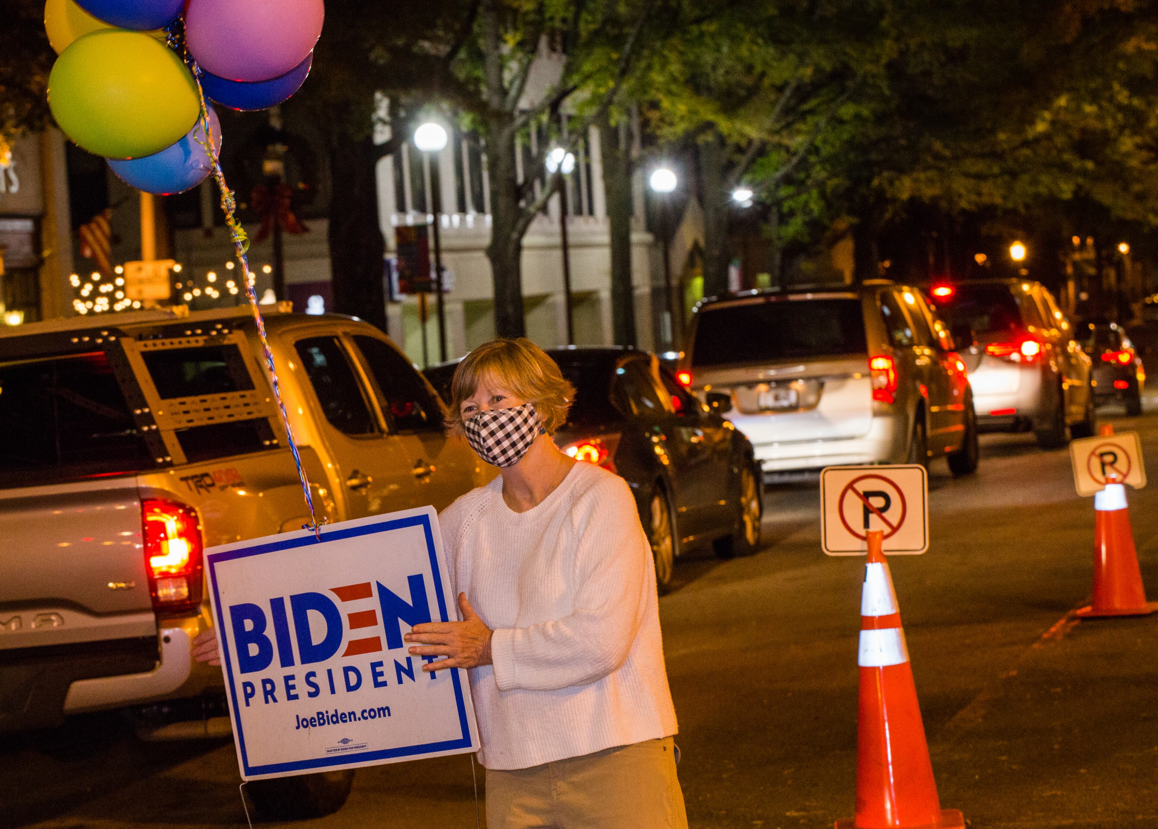 Nancy Wilkes of Decatur brought out balloons to cheer for President-Elect Joe Biden and VP Kamala Harris on Saturday, Nov 7, 2020 as celebrations begin along W Ponce de Leon Ave near Decatur Square. (Jenni Girtman for The Atlanta Journal-Constitution)