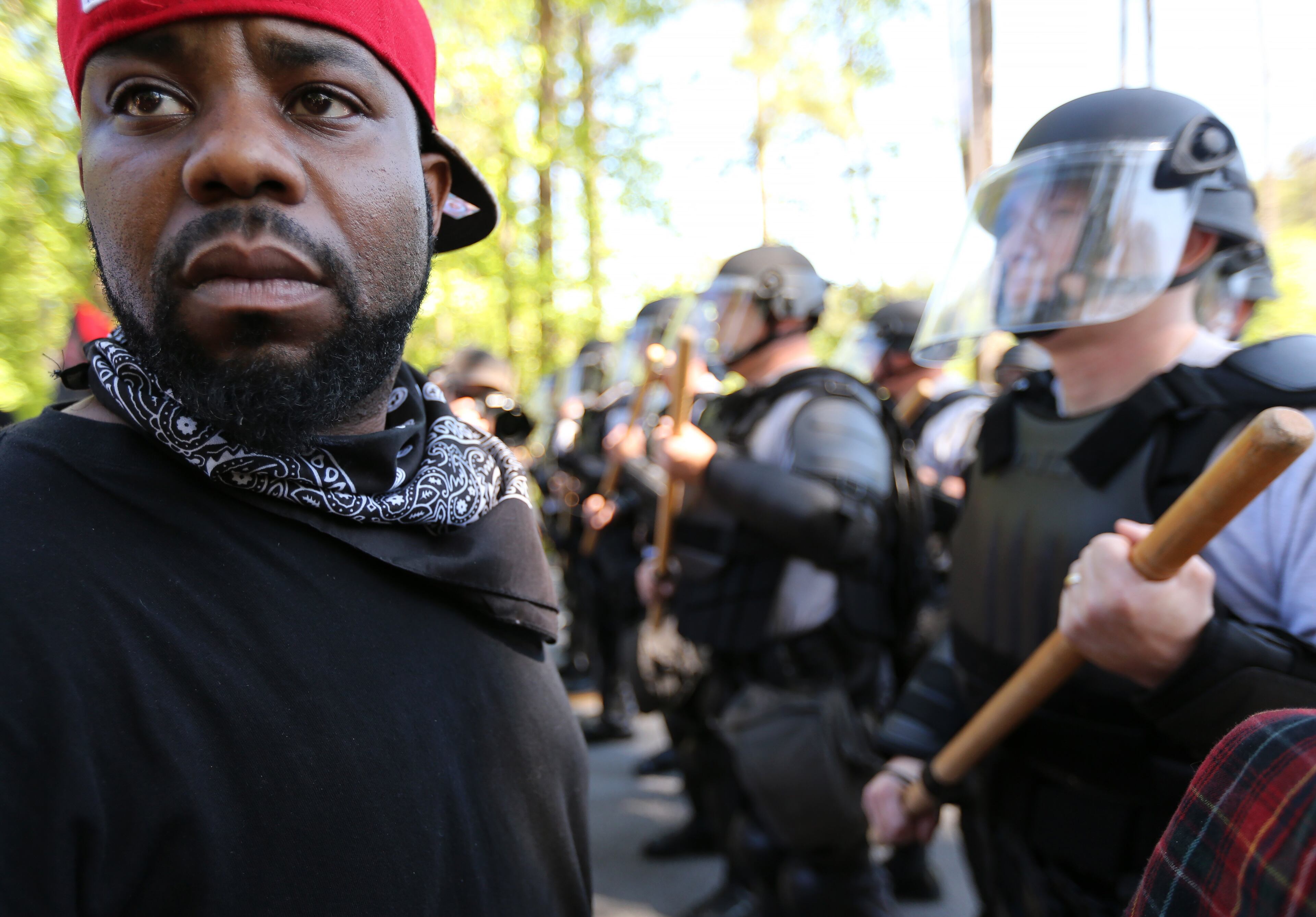 April 23, 2016 Stone Mountain: LaJuan Williams turns away from police while taking part in a counter protest at Stone Mountain Park on Saturday afternoon April 23, 2016. A white power protest and two counter protests were took place at the park. Ben Gray / bgray@ajc.com