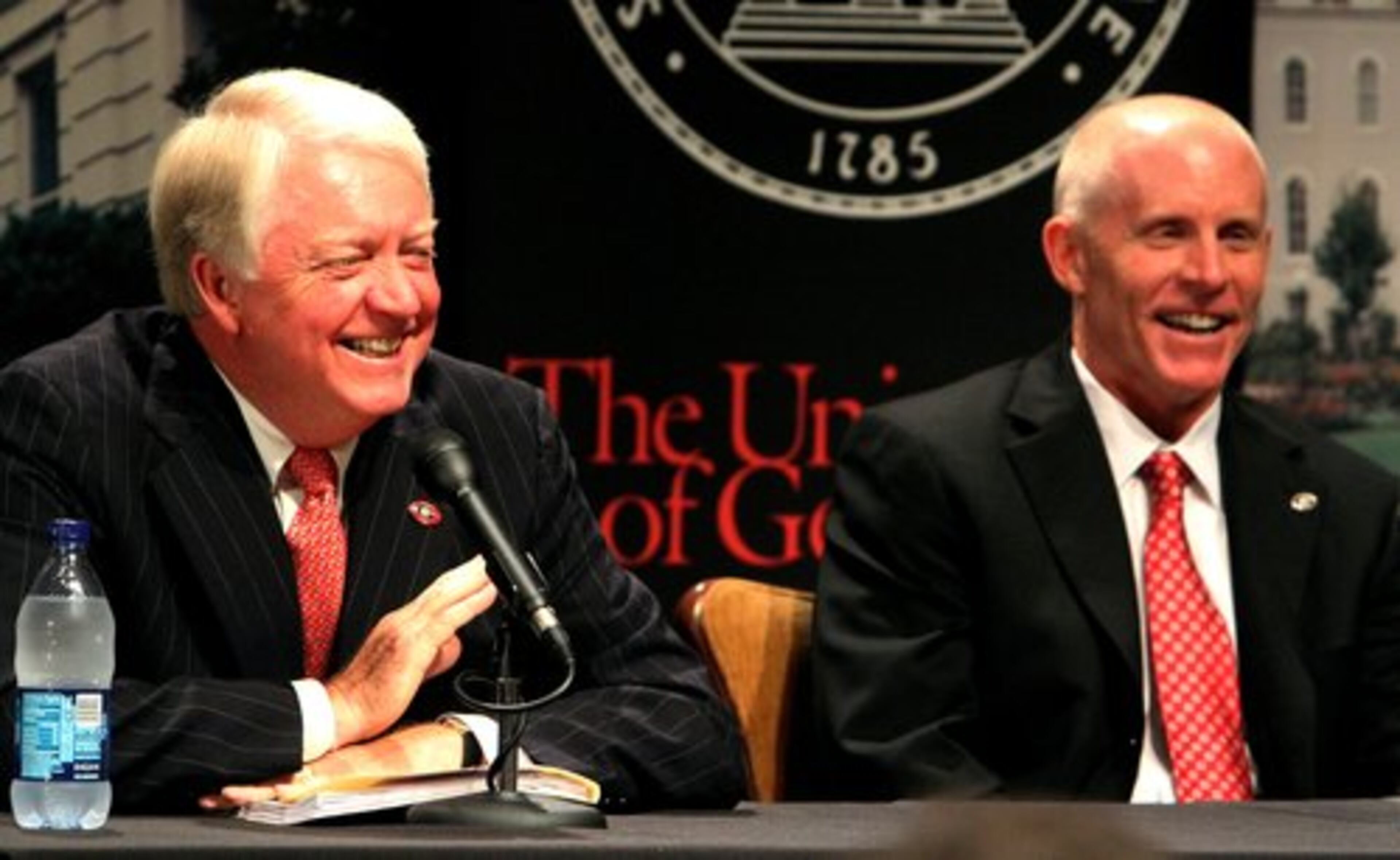 University of Georgia President Michael F. Adams shares a laugh with newly appointed interim athletic director Frank Crumley.