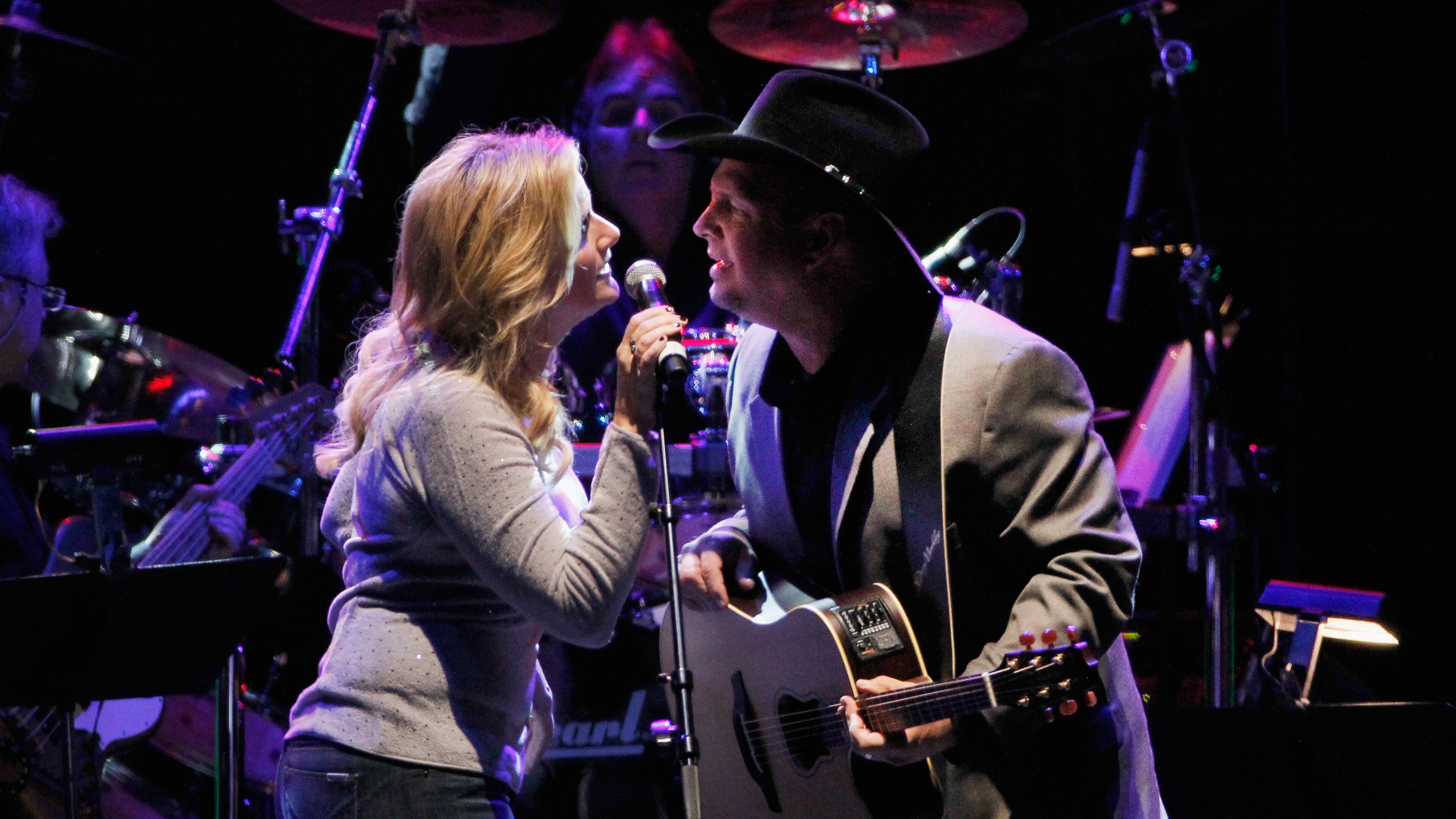 Trisha Yearwood and Garth Brooks perform at the Bridgestone Arena in Nashville in 2013. Terry Wyatt/Getty Images