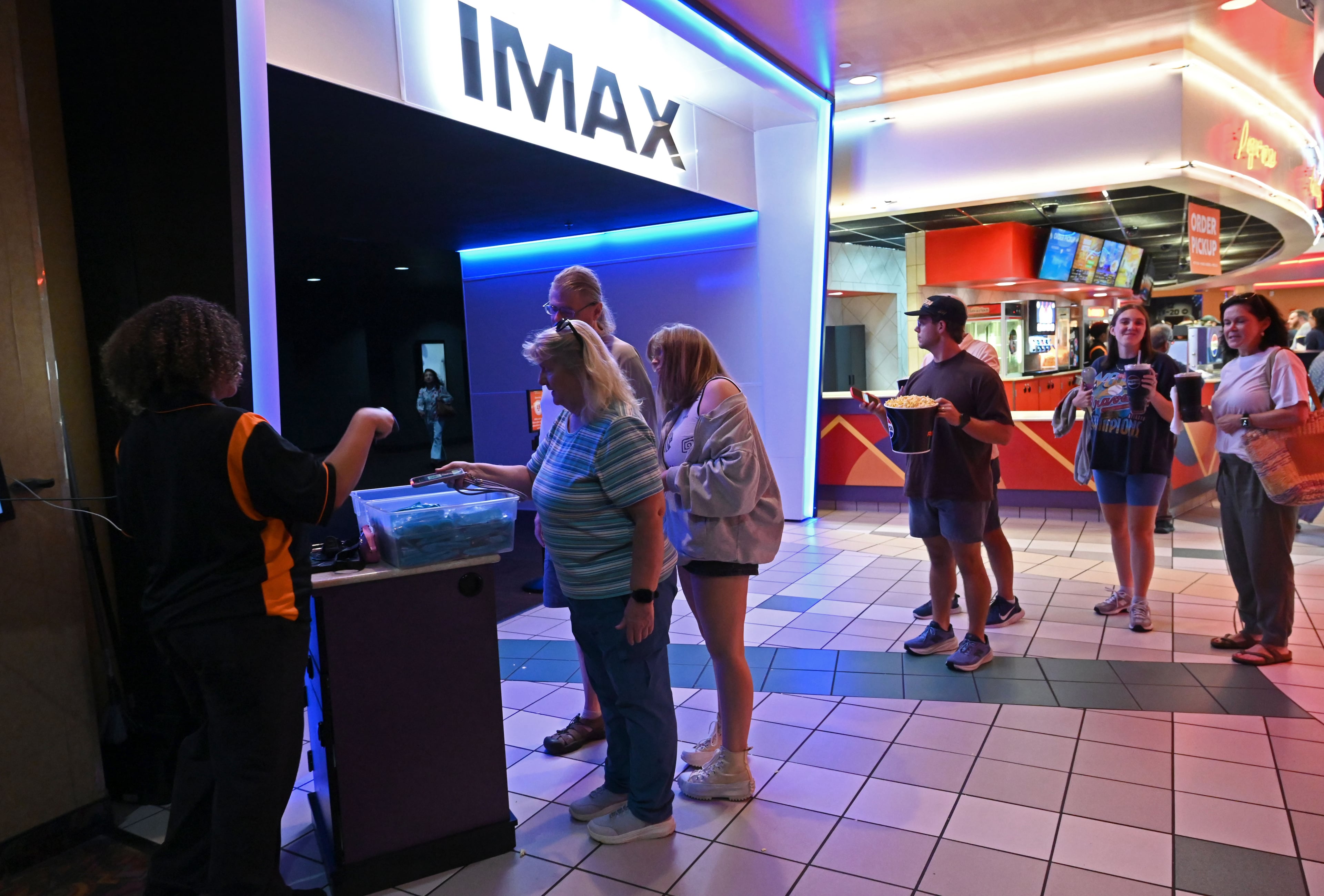 Moviegoers enter the cinema at the Regal Mall of Georgia to watch “The Odyssey” on Friday, Aug. 7, 2026, in Buford. The prime way to see the movie is through 70mm IMAX. (Hyosub Shin/AJC)