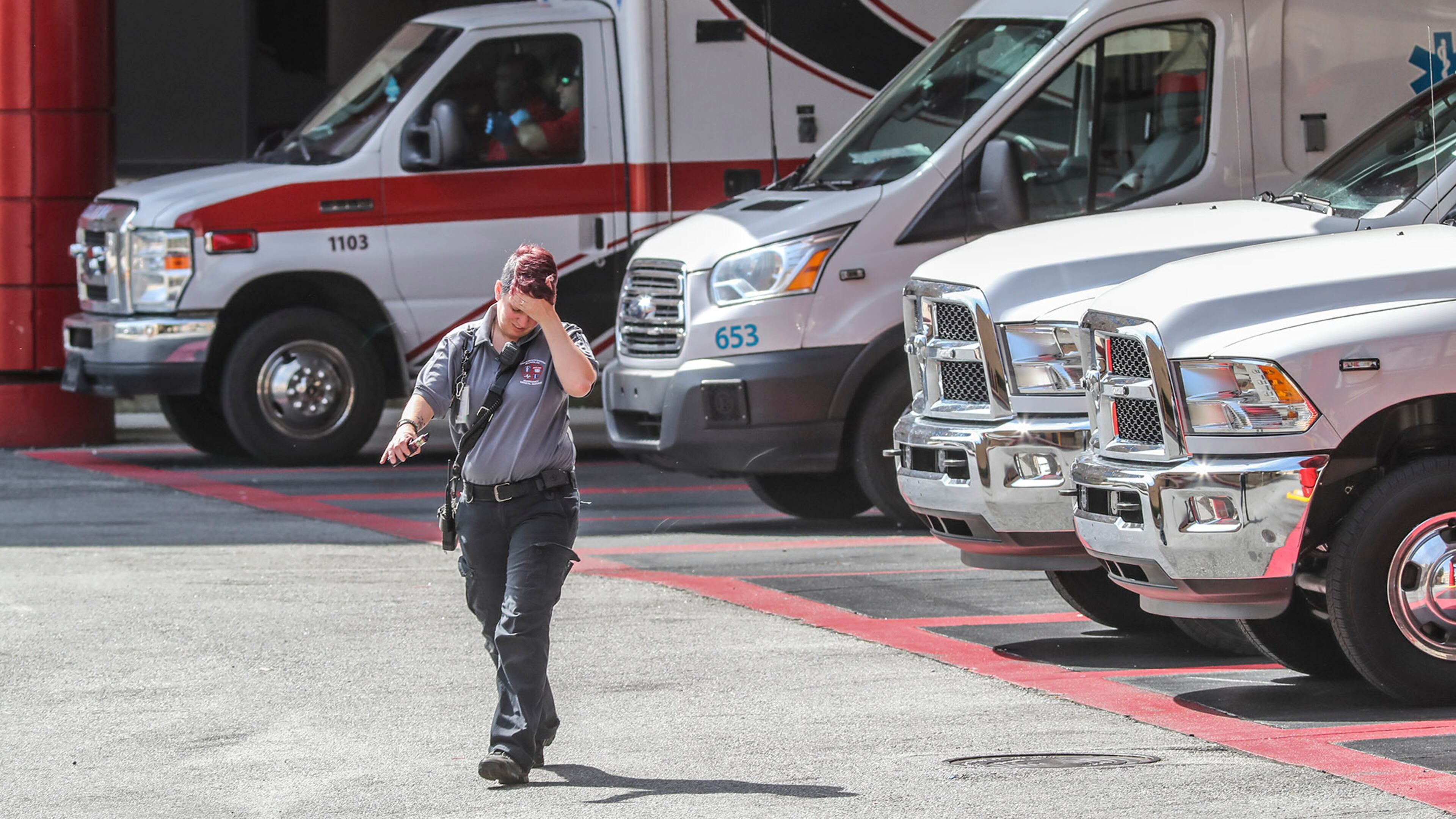 May 9, 2019 : Atlanta: A Grady ambulance driver walks away from ambulances lined up at Grady Hospital in Atlanta on Thursday May 9, 2019. Emergency Critics say Georgia's system of selecting ambulance providers needs a major overhaul, pointing to concerns -- rampant conflicts, lax oversight, no rules on vetting -- that put Georgians lives at risk at the most critical hour. JOHN SPINK/JSPINK@AJC.COM