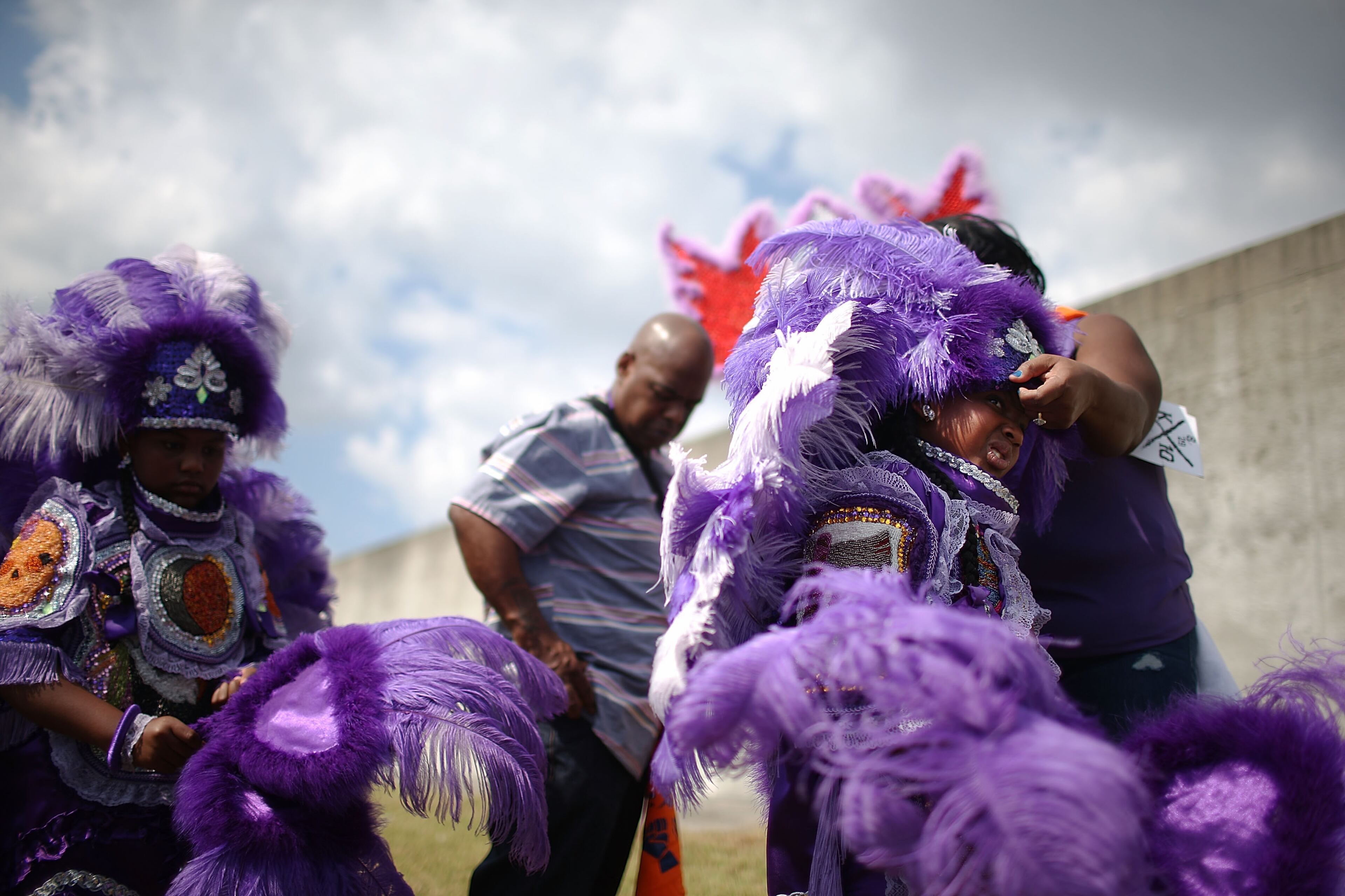 NEW ORLEANS, LA - AUGUST 29: Kids are dressed in Mardi Gras Indian costumes along the repaired levee wall in the Lower Ninth Ward on the 10th anniversary of Hurricane Katrina on August 29, 2015 in New Orleans, Louisiana. A levee breach along the Industrial Canal in the Lower Ninth Ward devastated the area with massive flooding in the aftermath of Hurricane Katrina. (Photo by Mario Tama/Getty Images)