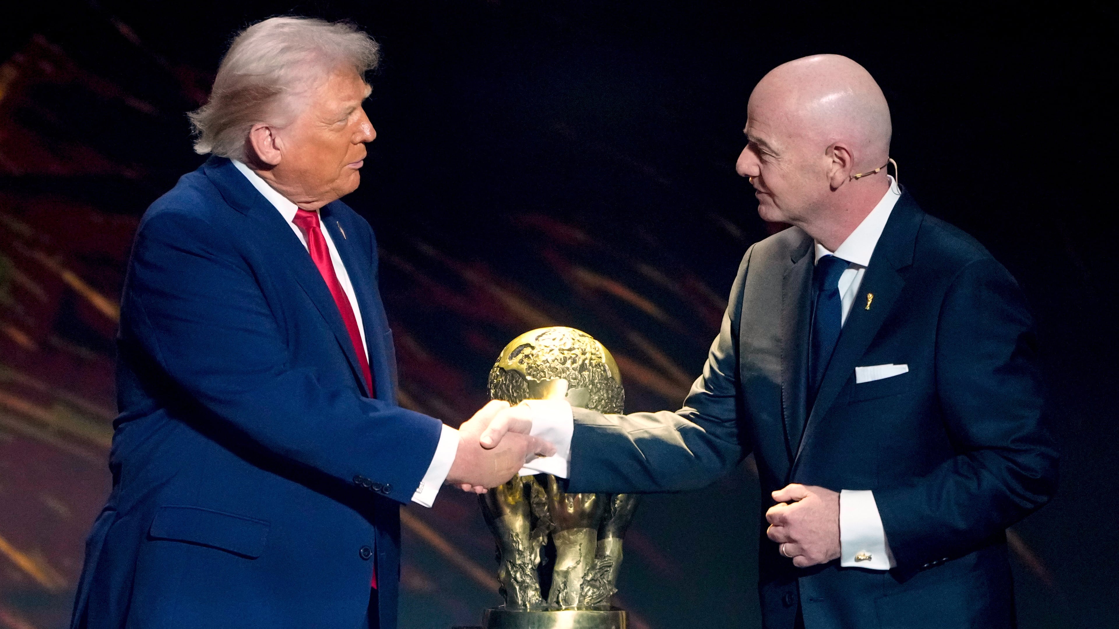 FILE - FIFA President Gianni Infantino, right, awards President Donald Trump with the FIFA Peace Prize during the draw for the 2026 soccer World Cup at the Kennedy Center in Washington, Dec. 5, 2025. (AP Photo/Chris Carlson, File)