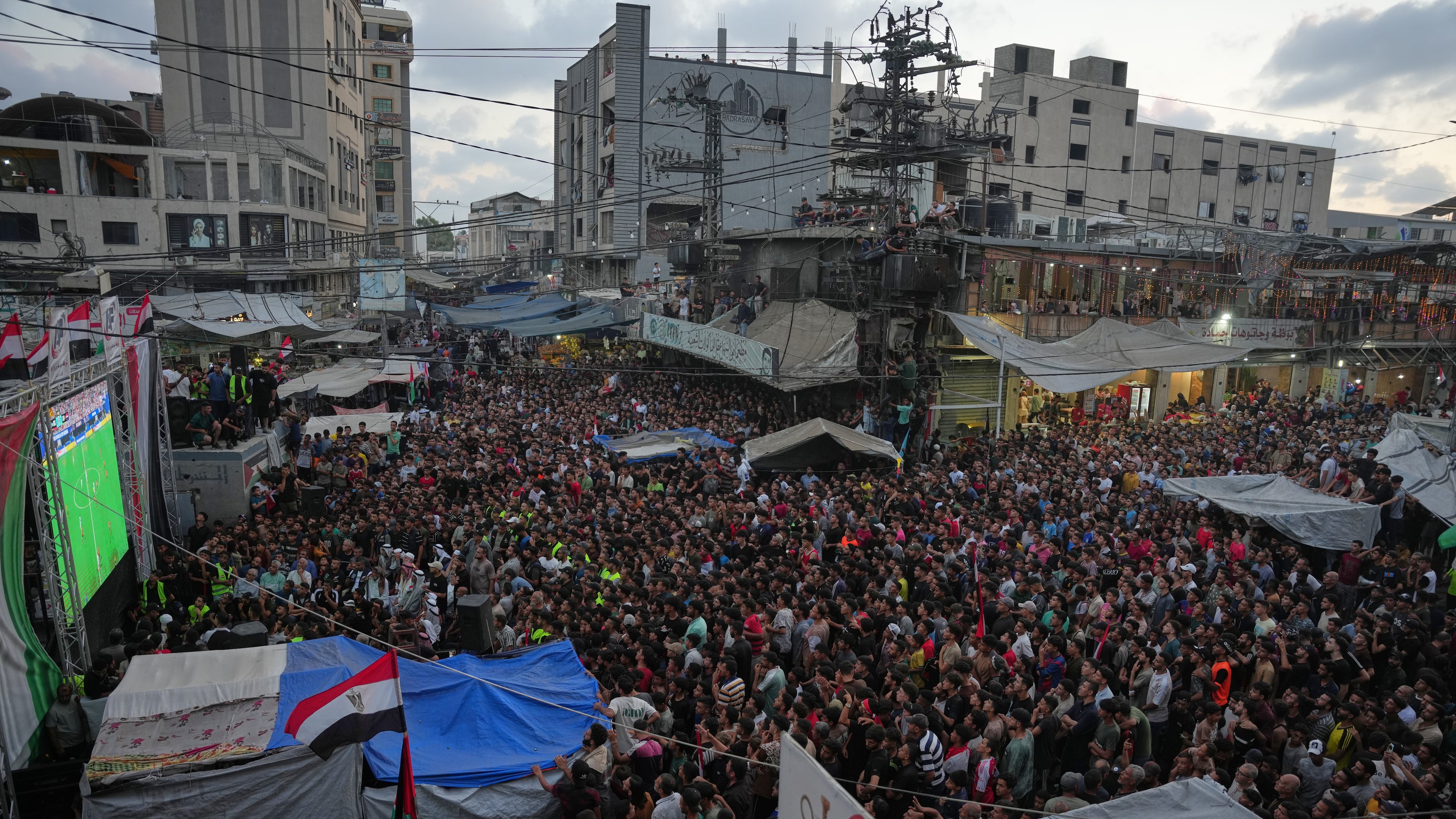 Palestinians watch a live broadcast of the World Cup round of 16 soccer match between Argentina and Egypt in Nuseirat, central Gaza Strip, Tuesday, July 7, 2026. (AP Photo/Abdel Kareem Hana)