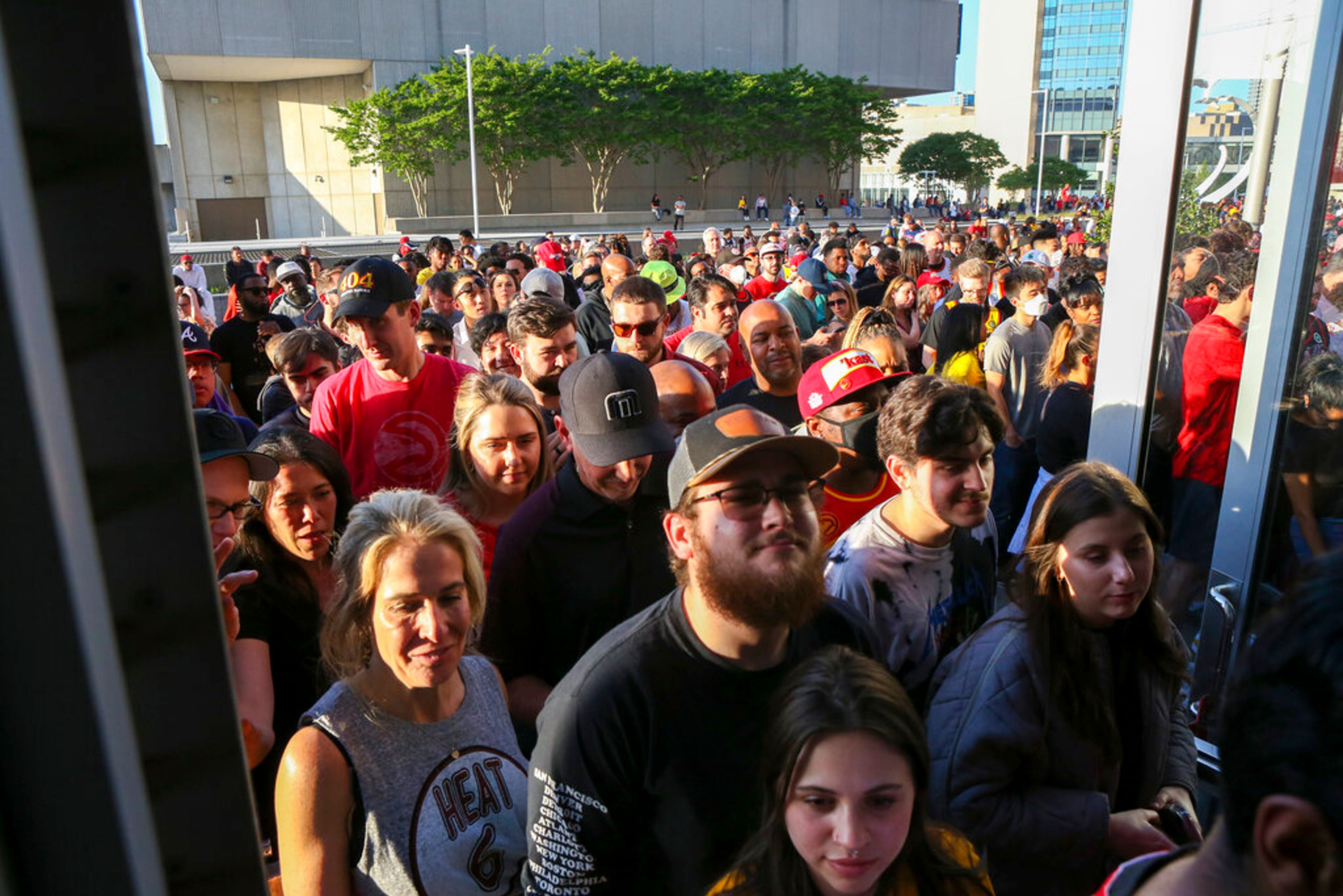 Fans enter a gate after three others were closed due to a suspicious package before Game 3 of an NBA basketball first-round playoff series between the Atlanta Hawks and the Miami Heat on Friday, April 22, 2022, in Atlanta. (AP Photo/Brett Davis)