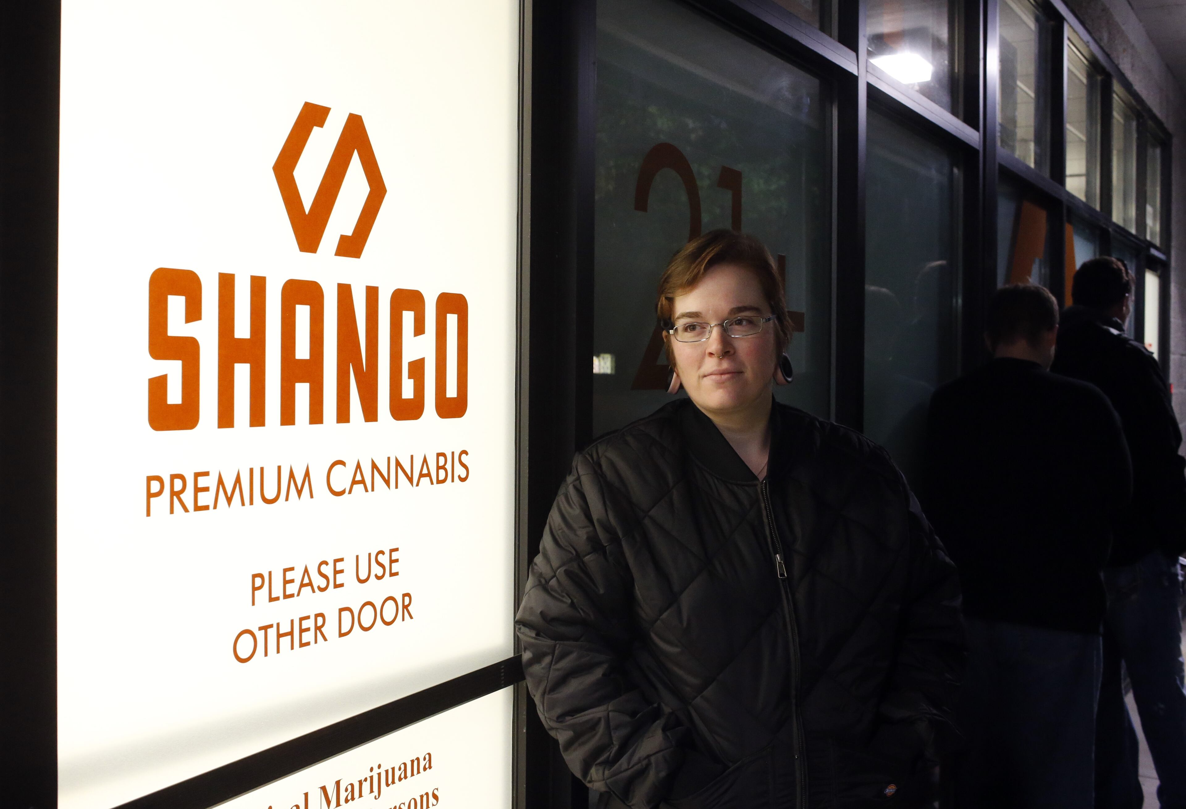Davia Fleming, 29, lines up outside of Shango Premium Cannabis, in Portland , Ore., Wednesday, Sept. 30, 2015. Oregon marijuana stores have begun sales to recreational users, marking a big day for the budding pot industry in the state. Some of the more than 250 dispensaries in Oregon that already offer medical marijuana opened their doors early Thursday to begin selling the drug just moments after it became legal to do so. (AP Photo/Timothy J. Gonzalez)