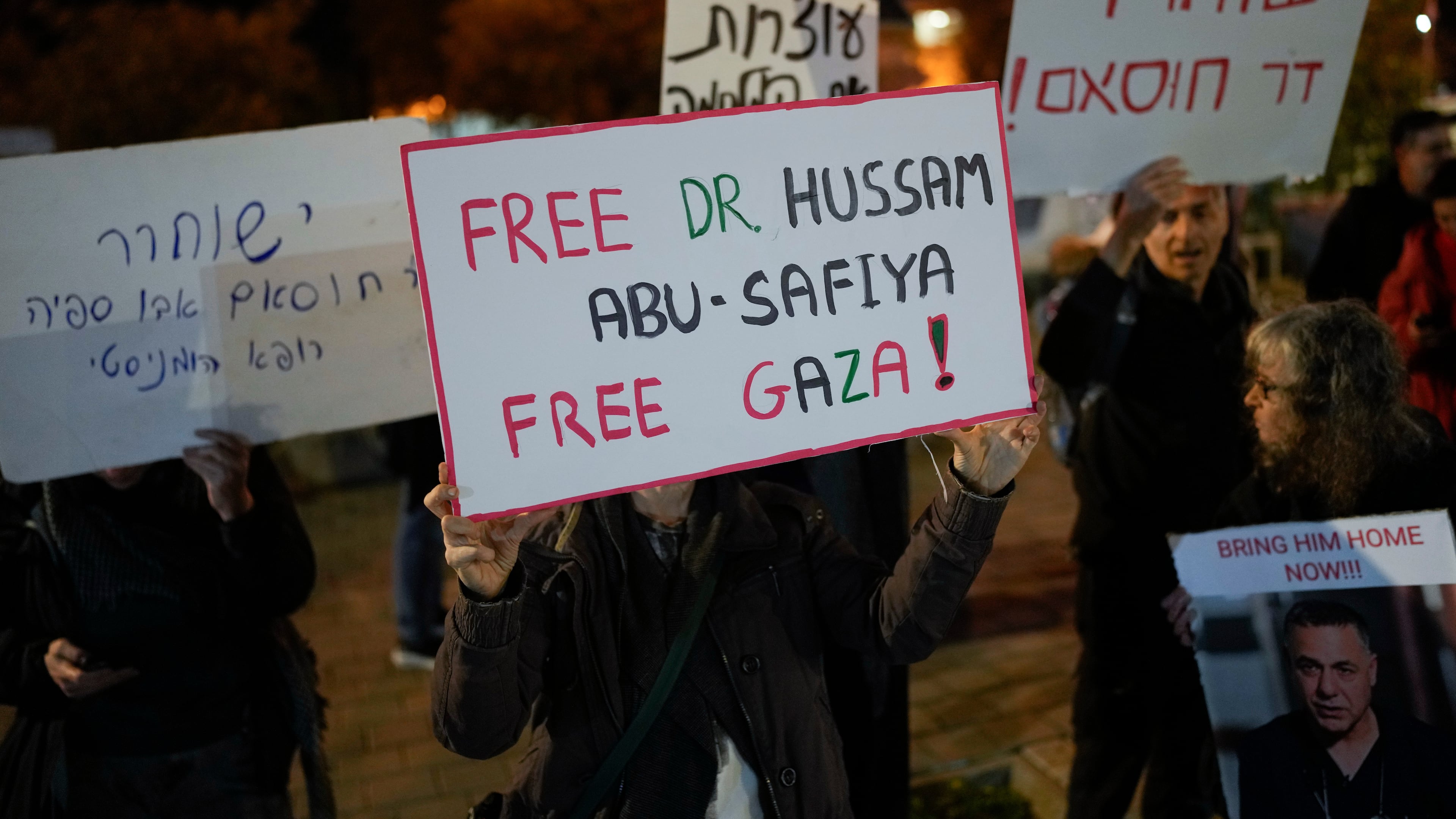 FILE - A woman holds a sign that reads "Free Dr. Hussam Abu Safiya, Free Gaza" during a protest in front of the Shin Bet offices, calling for his release, in Tel Aviv, Israel, on Jan. 1, 2025. (AP Photo/Matias Delacroix, File)