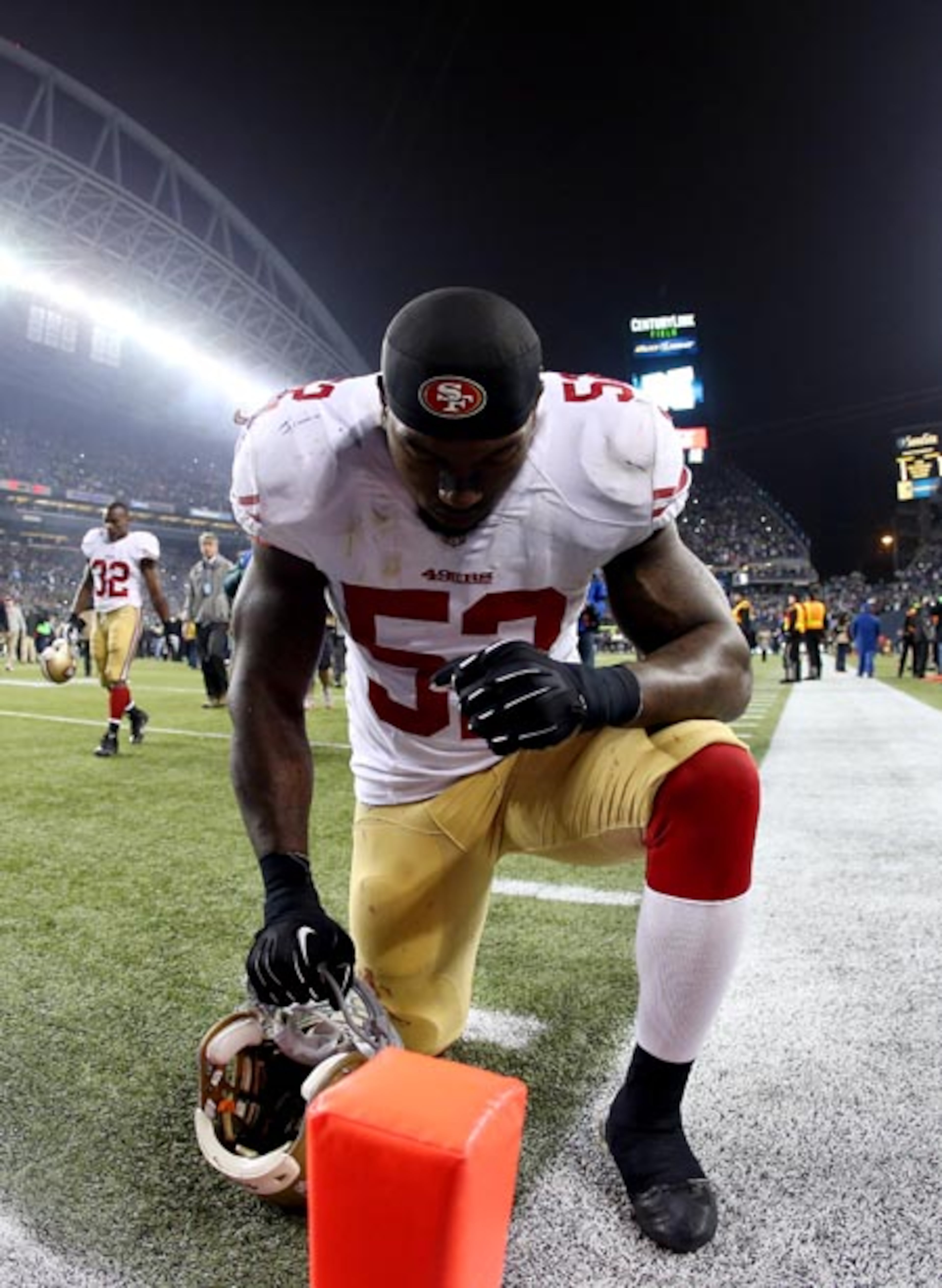 SEATTLE, WA - JANUARY 19: Linebacker Patrick Willis #52 of the San Francisco 49ers kneels down in the endzone after the Seattle Seahawks defeat the 49ers 23-17 during the 2014 NFC Championship at CenturyLink Field on January 19, 2014 in Seattle, Washington. (Photo by Christian Petersen/Getty Images)