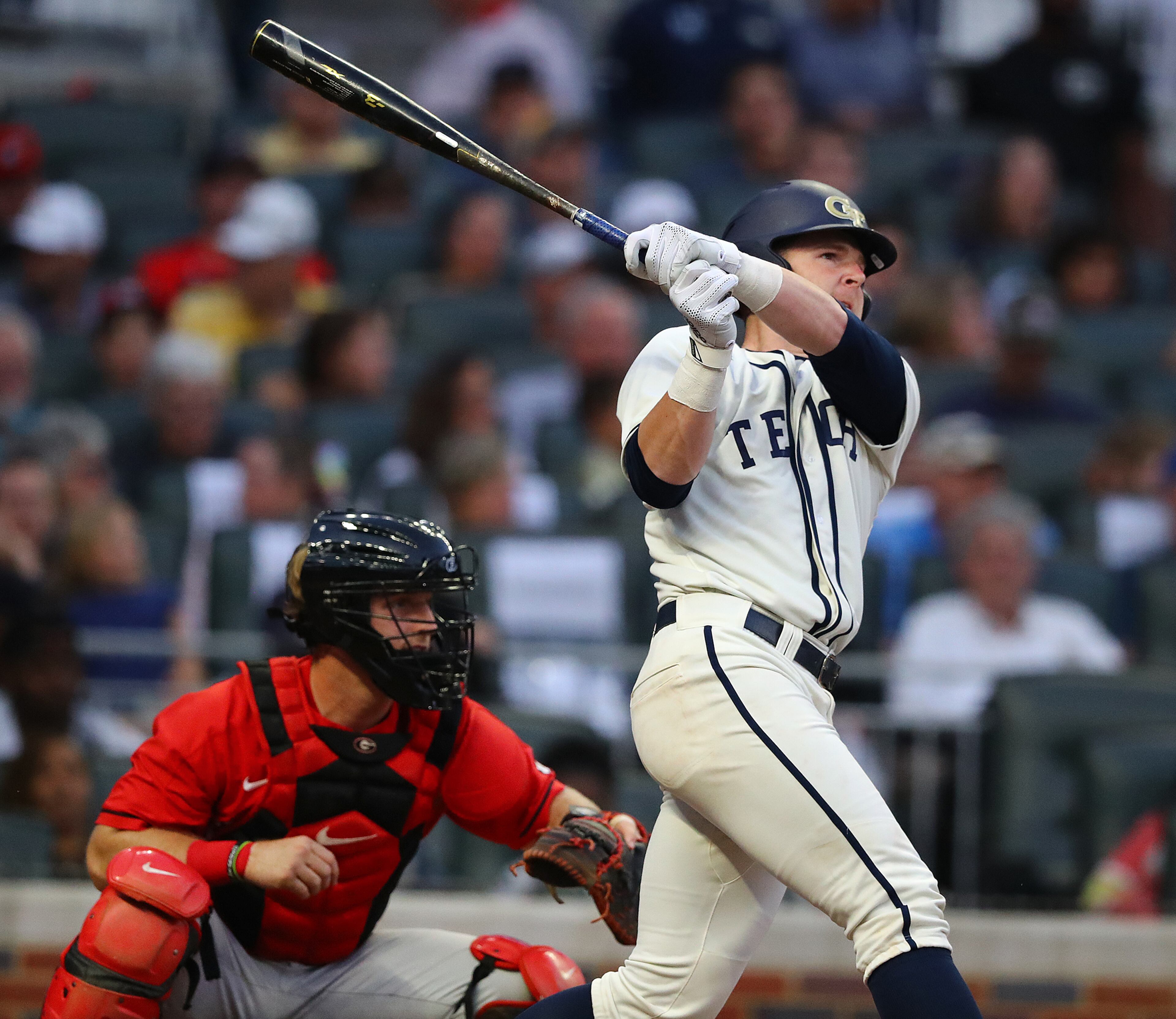 April 23, 2019 Atlanta: Georgia Tech catcher Kyle McCann hits a 3-RBI home run to take a 6-2 lead over Georgia with catcher Mason Meadows looking on during the second inning in the Spring Classic NCAA college baseball game at SunTrust Park on Tuesday, April 23, 2019, in Atlanta. Curtis Compton/ccompton@ajc.com
