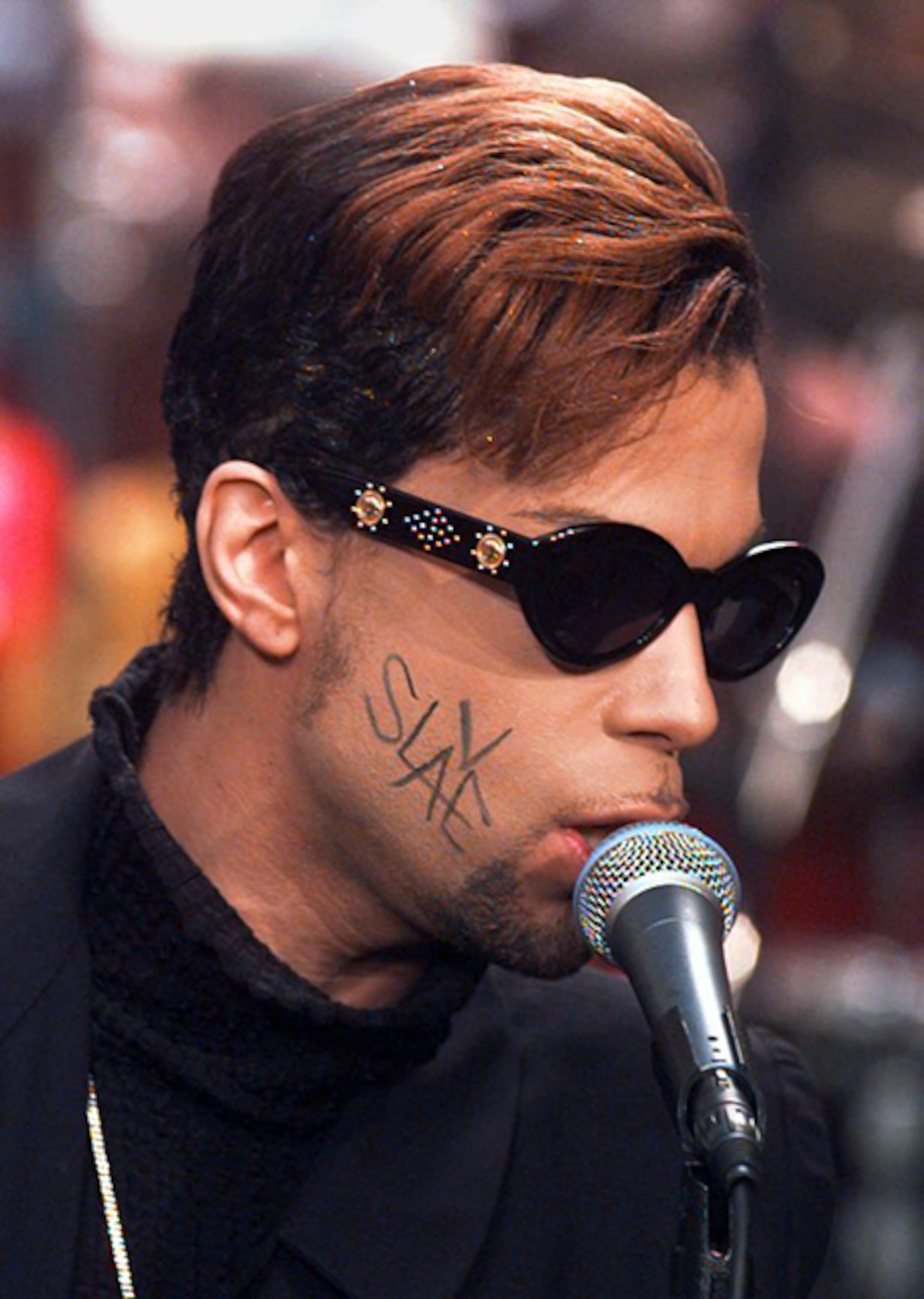 The Artist Formerly Known as Prince, with the word "Slave" written across his face, belts out a tune from his new CD, "Chaos and Disorder," outside the studio of NBC's "Today" show in New York's Rockefeller Plaza on July 9, 1996.