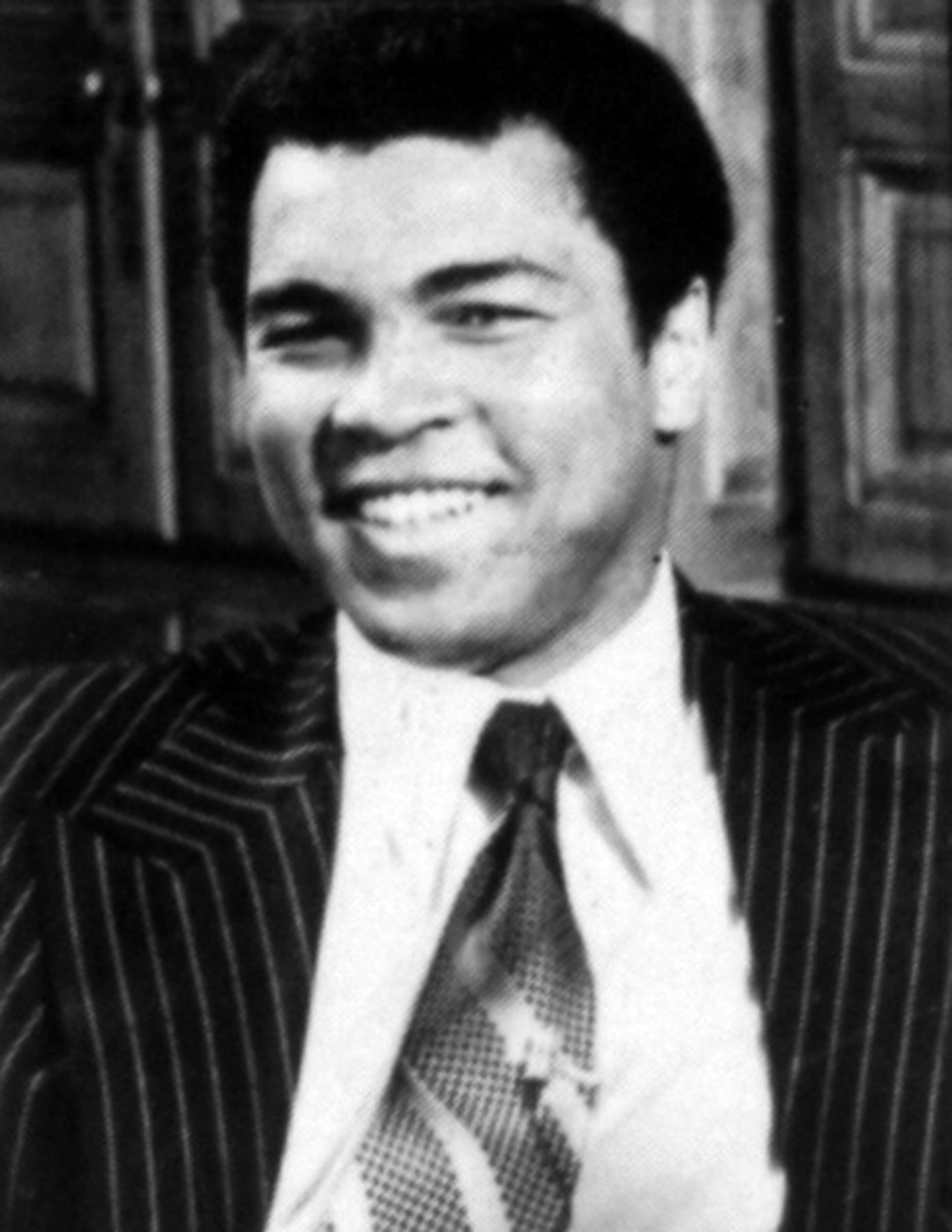 Boxer Muhammad Ali smiles in a suit and tie, 1960. (Photo by Afro American Newspapers/Gado/Getty Images)