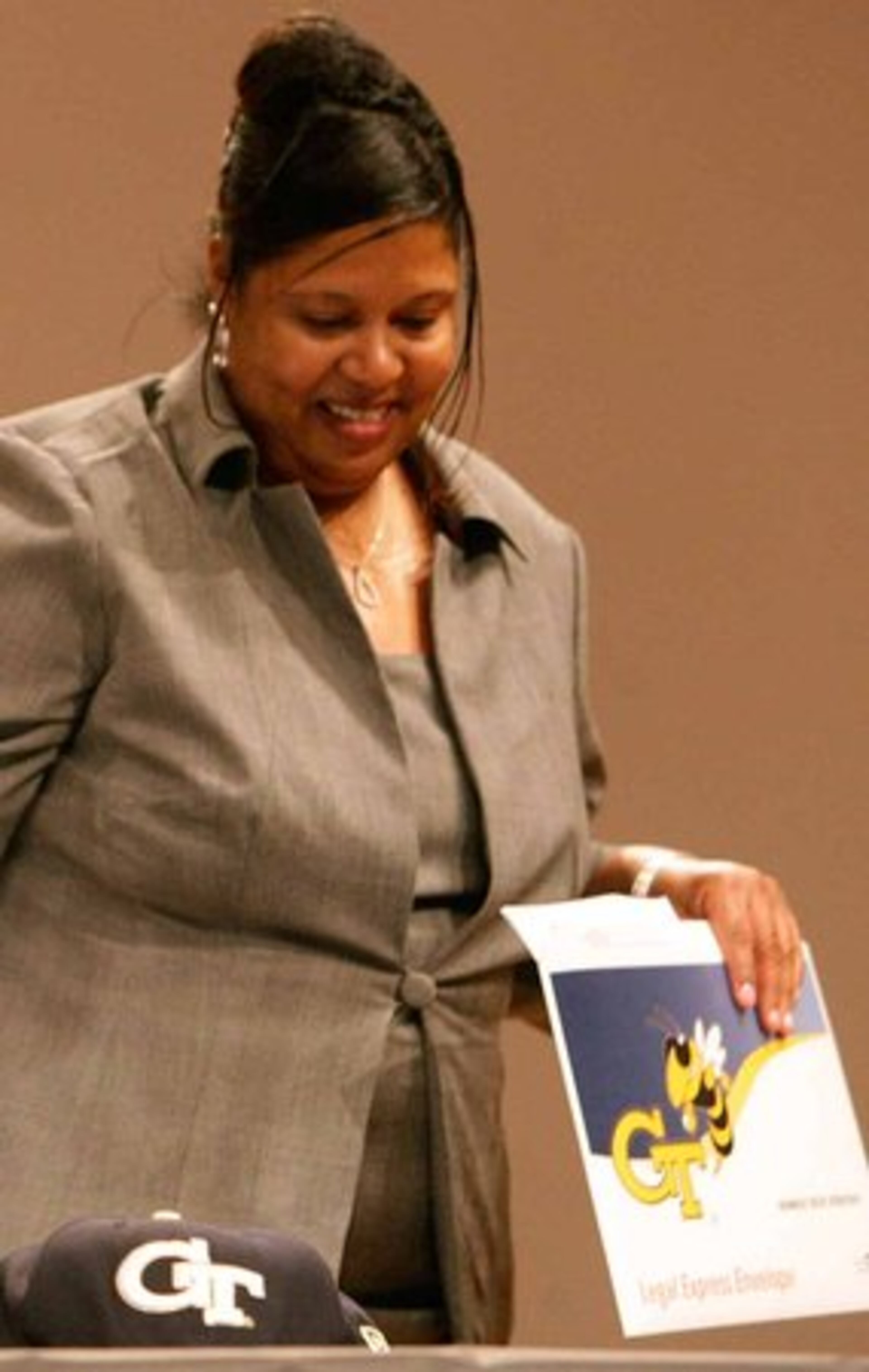 Mom Deandra Favors is all smiles after the signing ceremony. Son Derrick said he chose Tech because "it's a good academic school and I wanted all my friends to be able to see me play." - Larry Hartstein