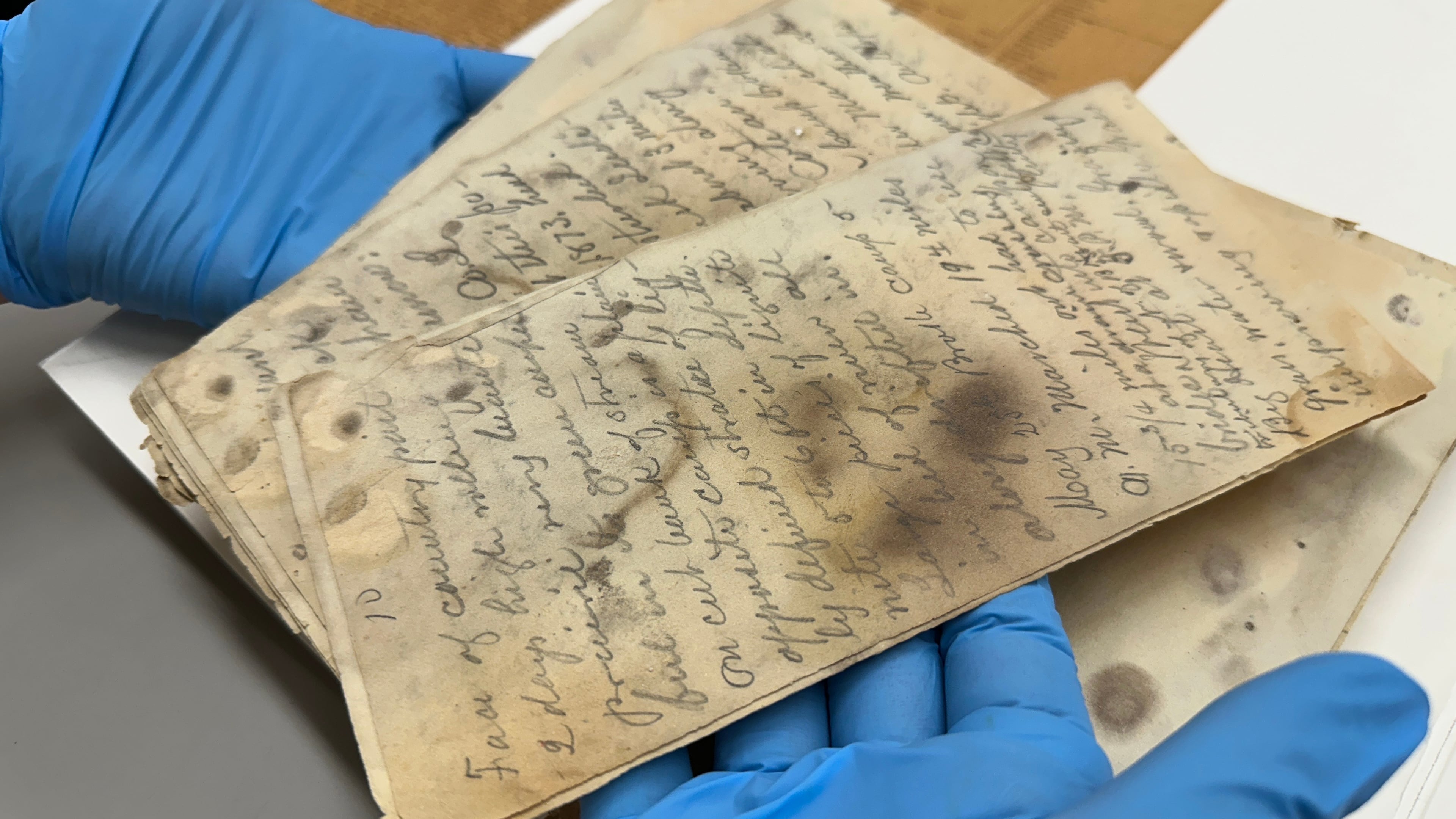 State Historical Society of North Dakota Deputy State Archivist Lindsay Meidinger holds pages of the diary of Mark Kellogg, a reporter killed during the Battle of the Little Bighorn in 1876, at the North Dakota Heritage Center and State Museum in Bismarck, N.D., Wednesday, June 24, 2026. (AP Photo/Jack Dura
