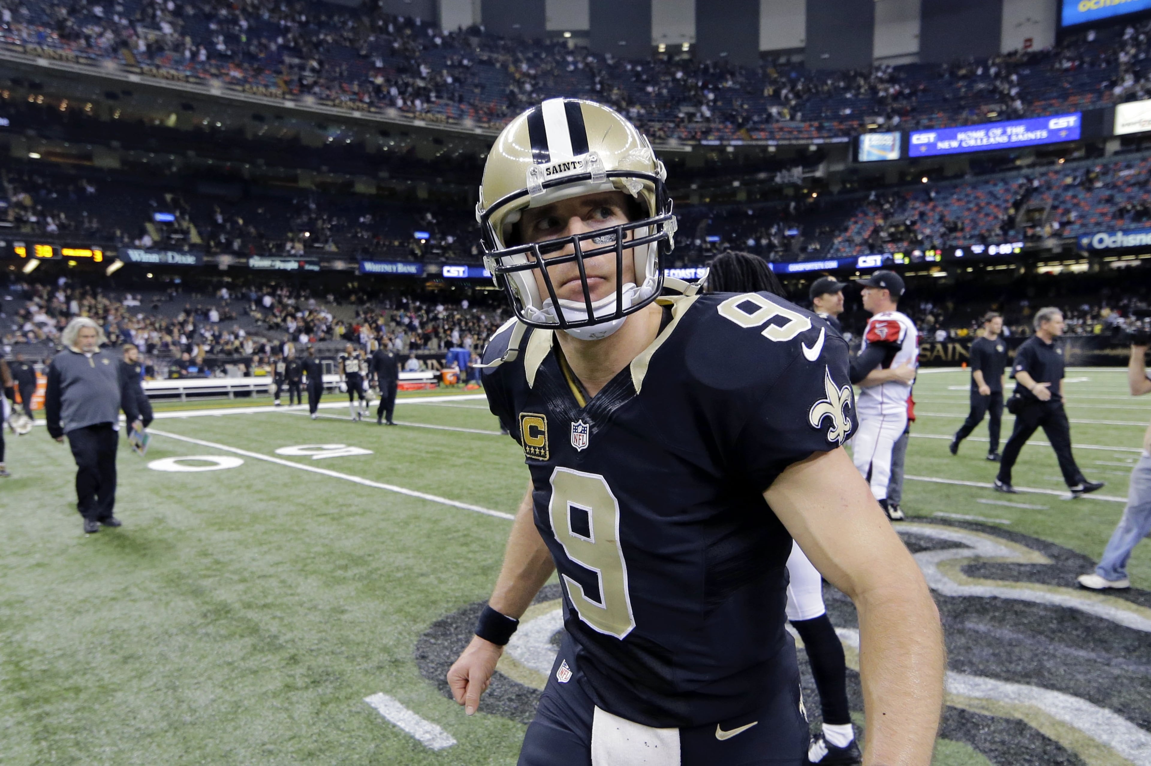 New Orleans Saints quarterback Drew Brees (9) walks off the field after their loss to the Atlanta Falcons in an NFL football game in New Orleans, Sunday, Dec. 21, 2014. The Falcons won 30-14. (AP Photo/Bill Haber)