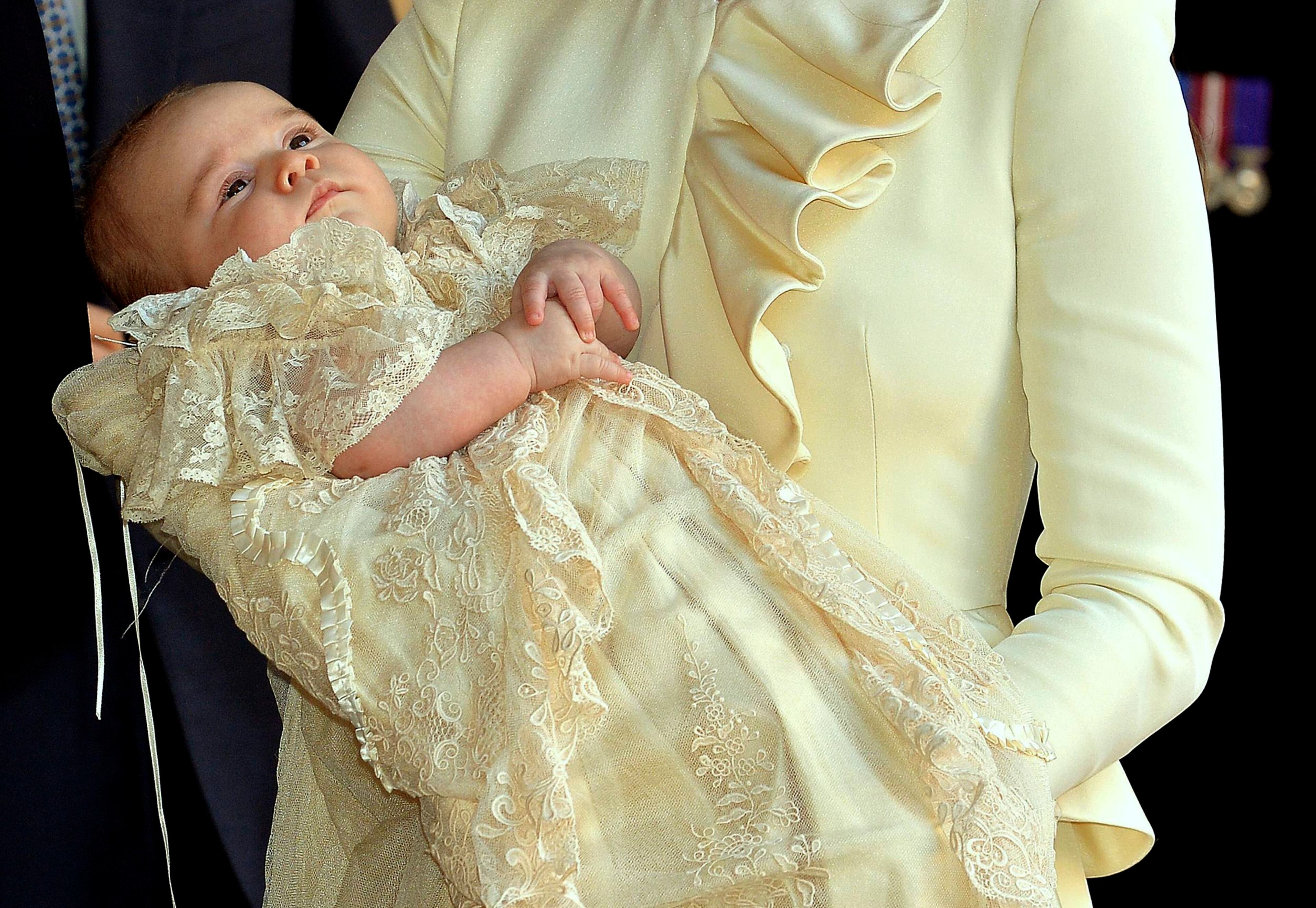 Britain's Catherine, Duchess of Cambridge carries her son Prince George after his christening at St James's Palace in London October 23, 2013. REUTERS/John Stillwell/pool