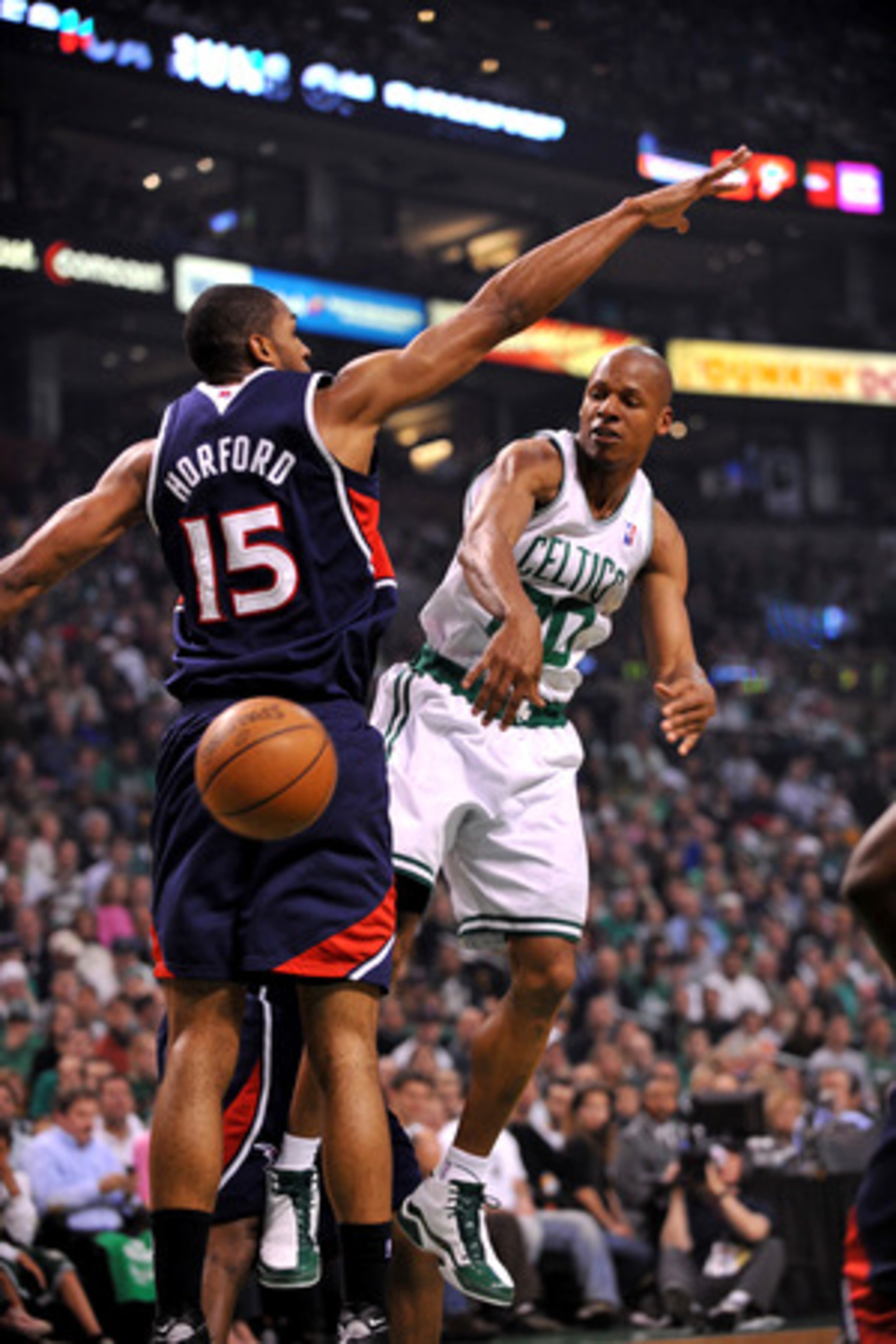 Celtics guard Ray Allen sneaks a pass past the Hawks' Al Horford.