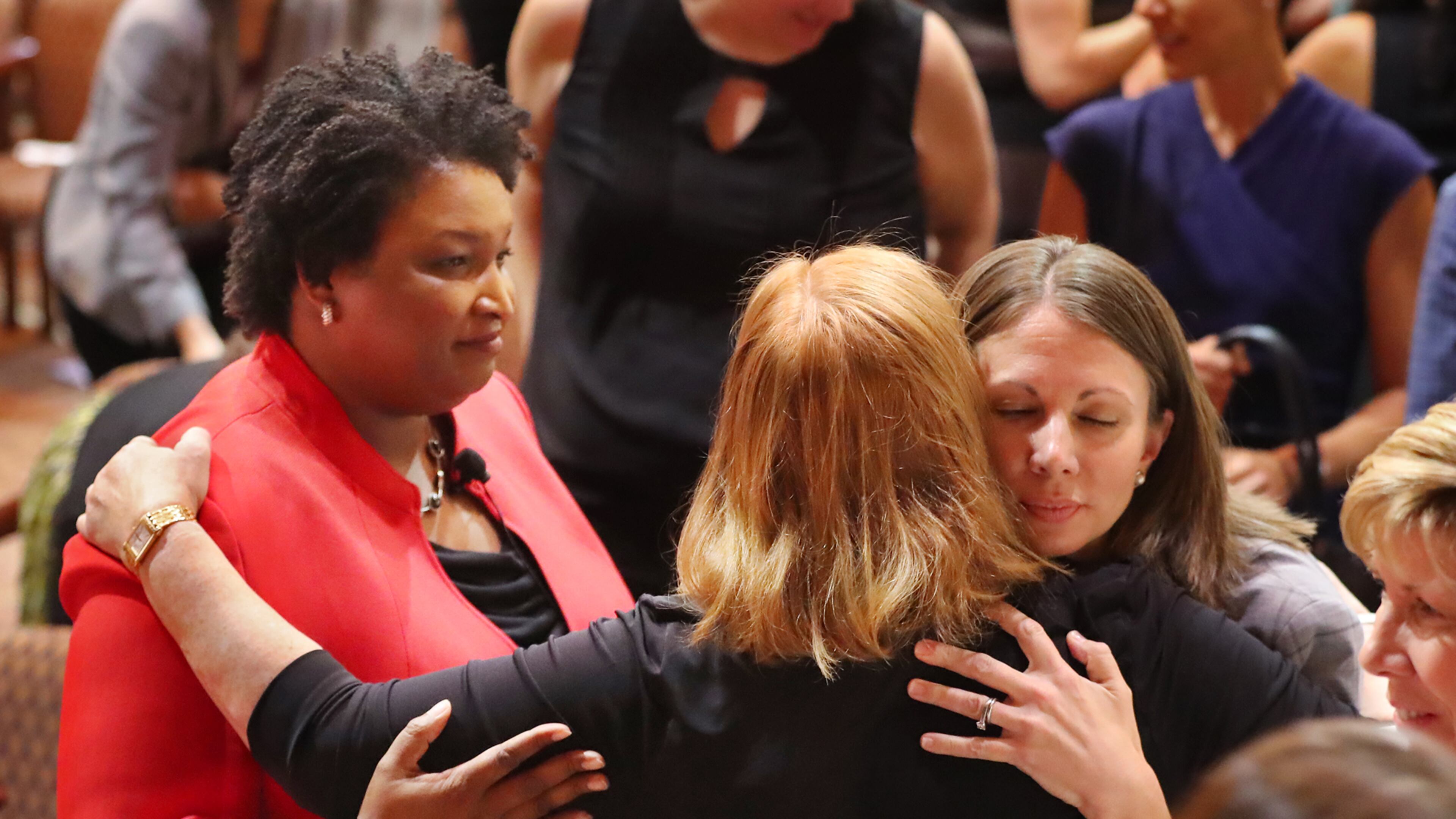 Democratic candidates for governor Stacey Abrams (left) and Stacey Evans (right) greet supporters after their first forum last October. Curtis Compton/ccompton@ajc.com