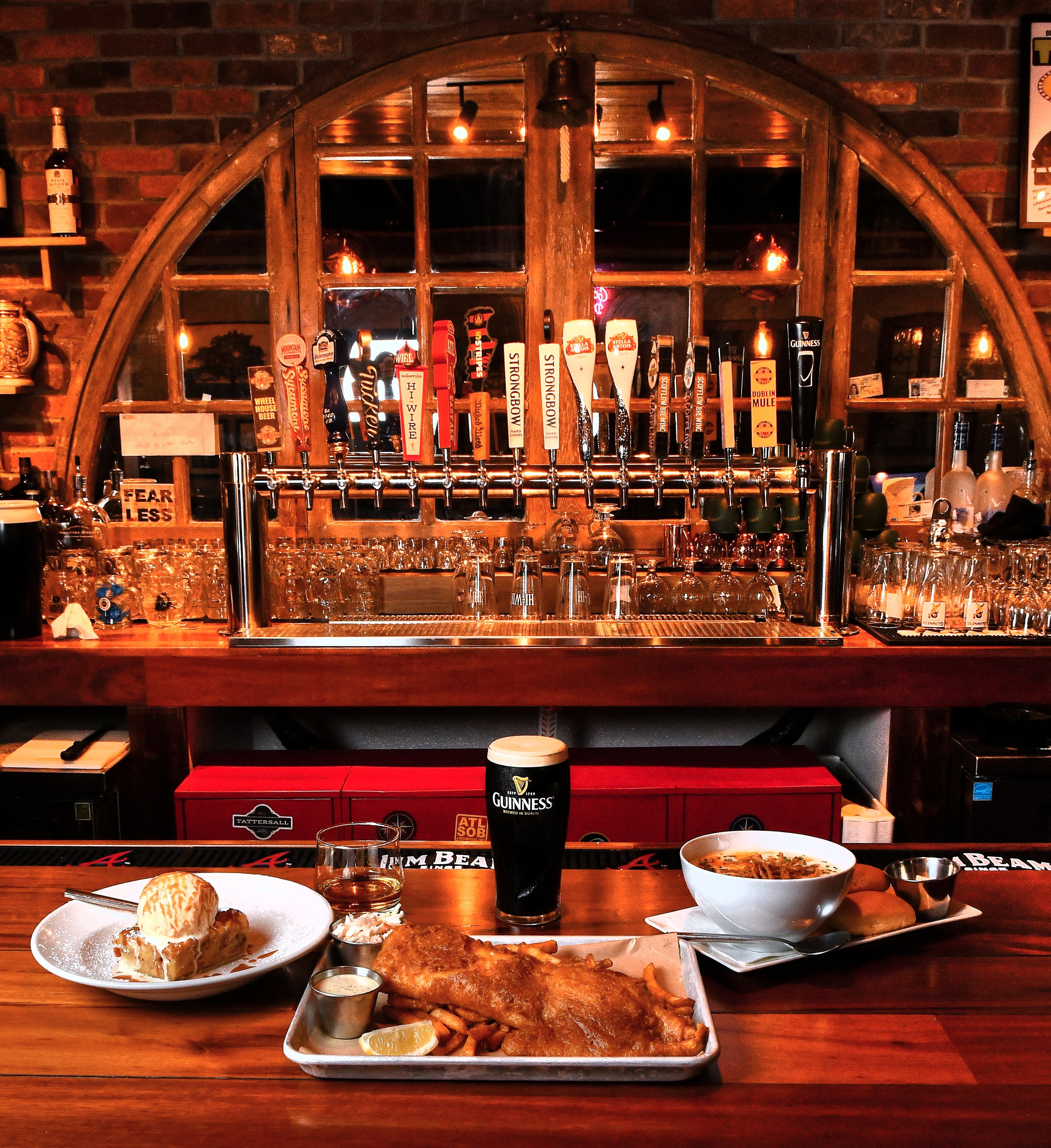Get in the St. Patrick's Day spirit with recipes from Wheelhouse Craft Pub and Kitchen: (from left) Irish Bread Pudding (with Slane Irish Whiskey), Ale Battered Fried Fish (with a Guinness Stout), and Leek and Potato Soup. (Styling by Ian Macken / Chris Hunt for the AJC)