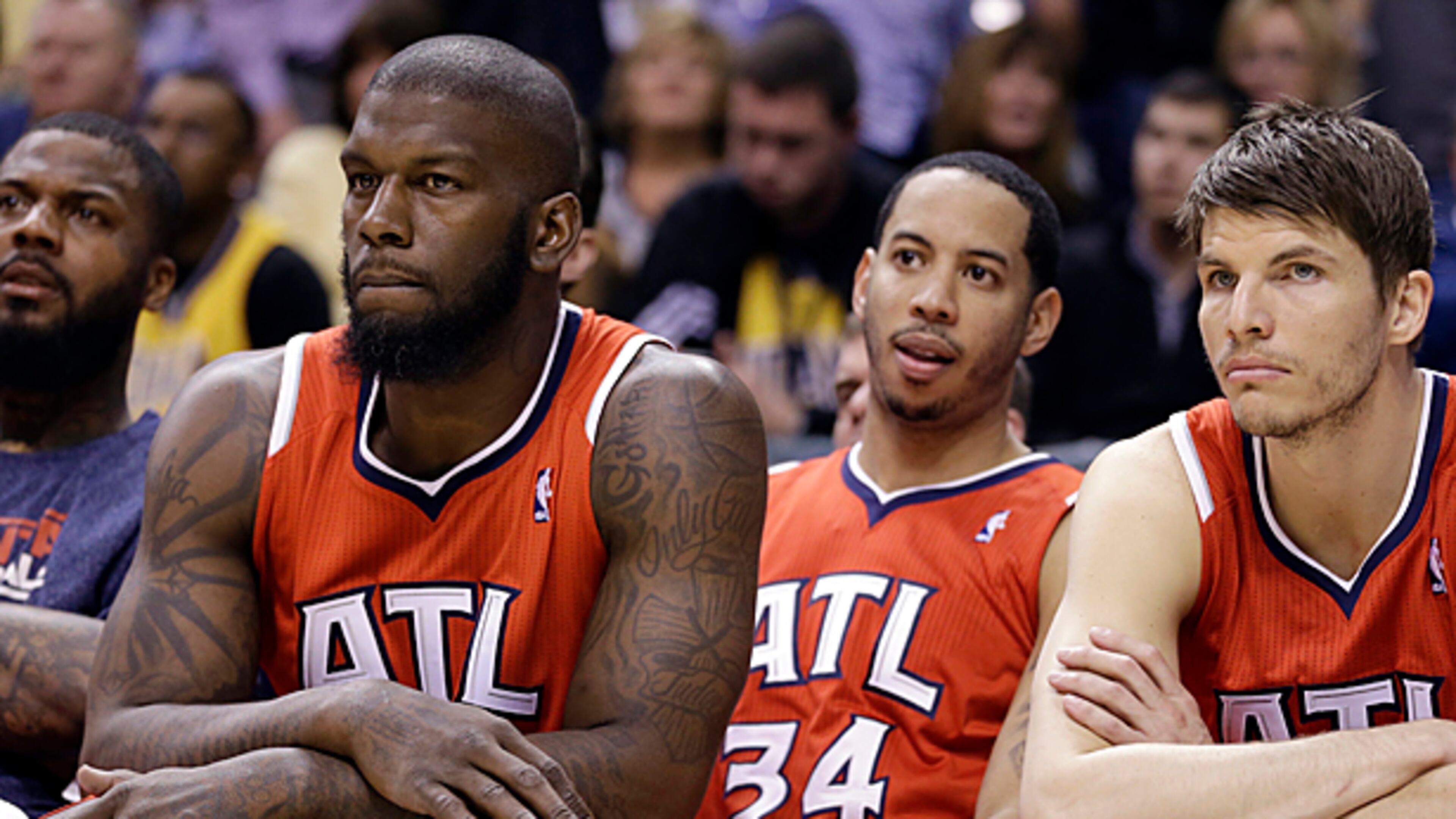 From left, Atlanta Hawks forward Ivan Johnson, guard Devin Harris and forward Kyle Korver watch front the bench late in the second half of Game 2 of a first-round NBA basketball playoff series against the Indiana Pacers in Indianapolis, Wednesday, April 24, 2013. The Pacers won 113-98. (AP Photo/Michael Conroy)