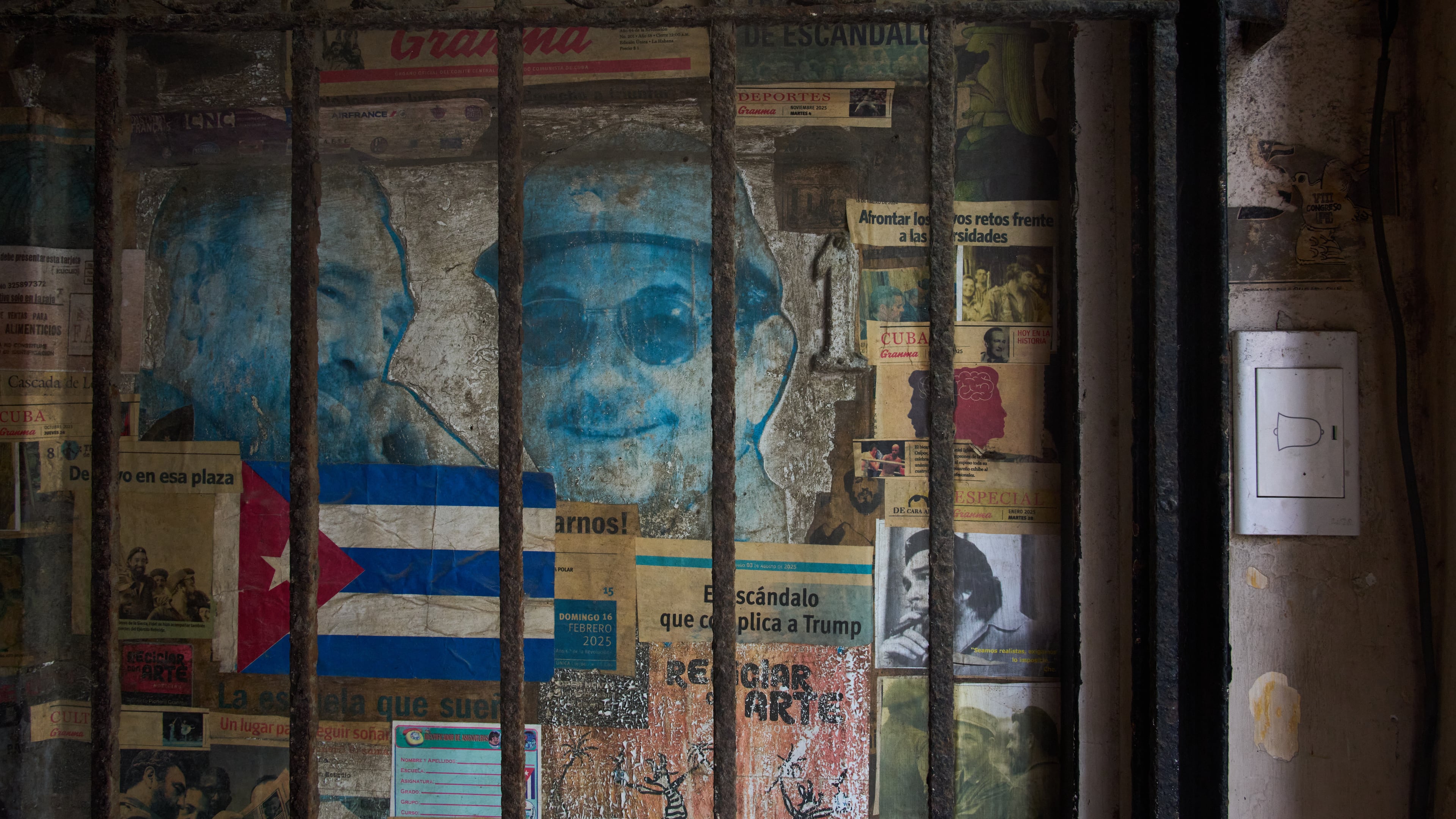 Photos of former Presidents Raúl Castro, right, and his late brother Fidel Castro cover a front door in Havana, Monday, Oct. 19, 2026. (AP Photo/Ramon Espinosa)