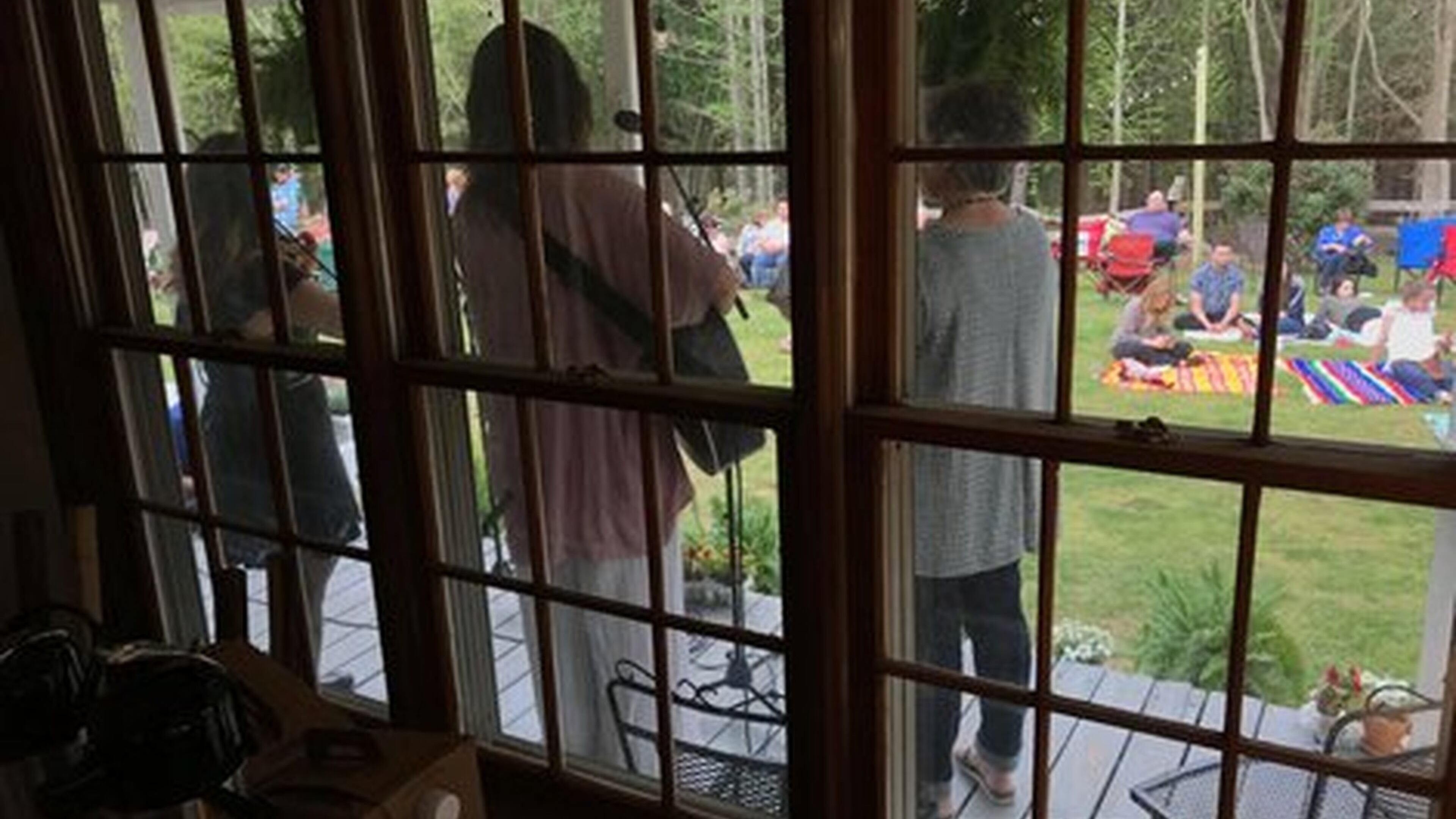 Friends share music on Paul and Jessica Vaughan’s back porch earlier this year in Lilburn. The couple said they hope to use the old Garner Farm to help others and foster community. CONTRIBUTED