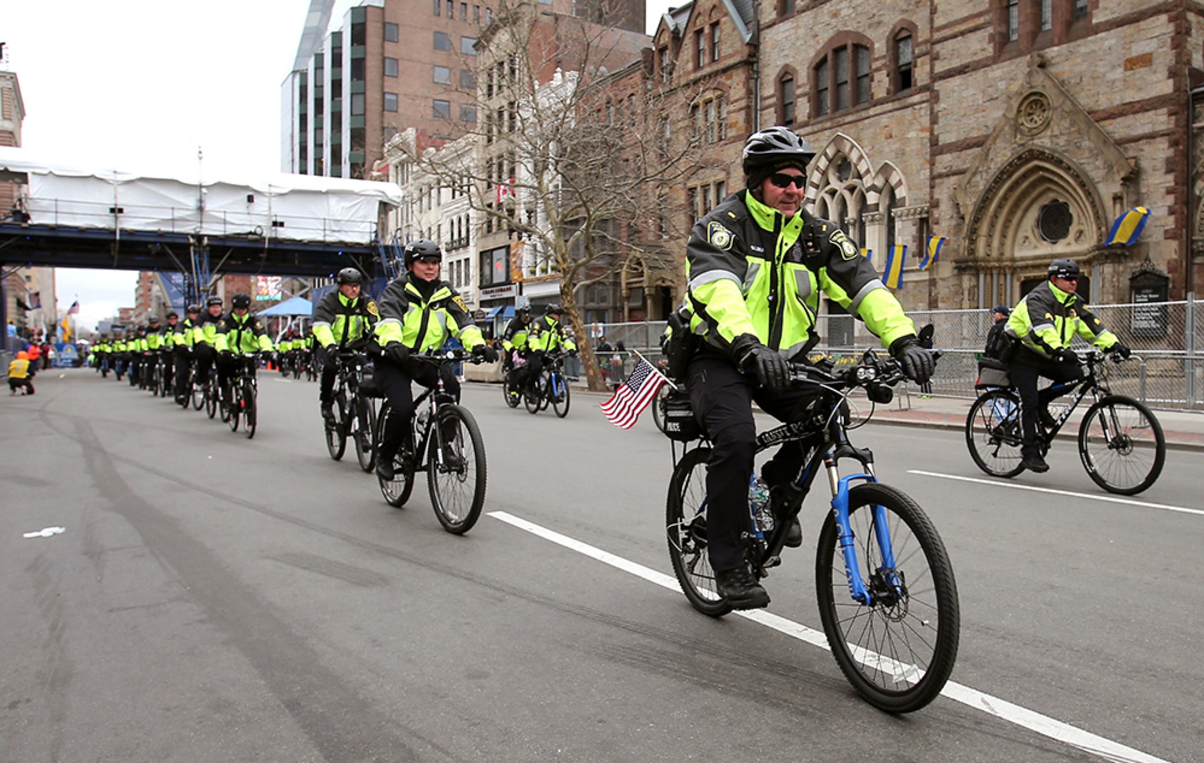 Police offiers ride bikes near the finish line before the start of the 119th Boston Marathon on April 20, 2015, in Boston.