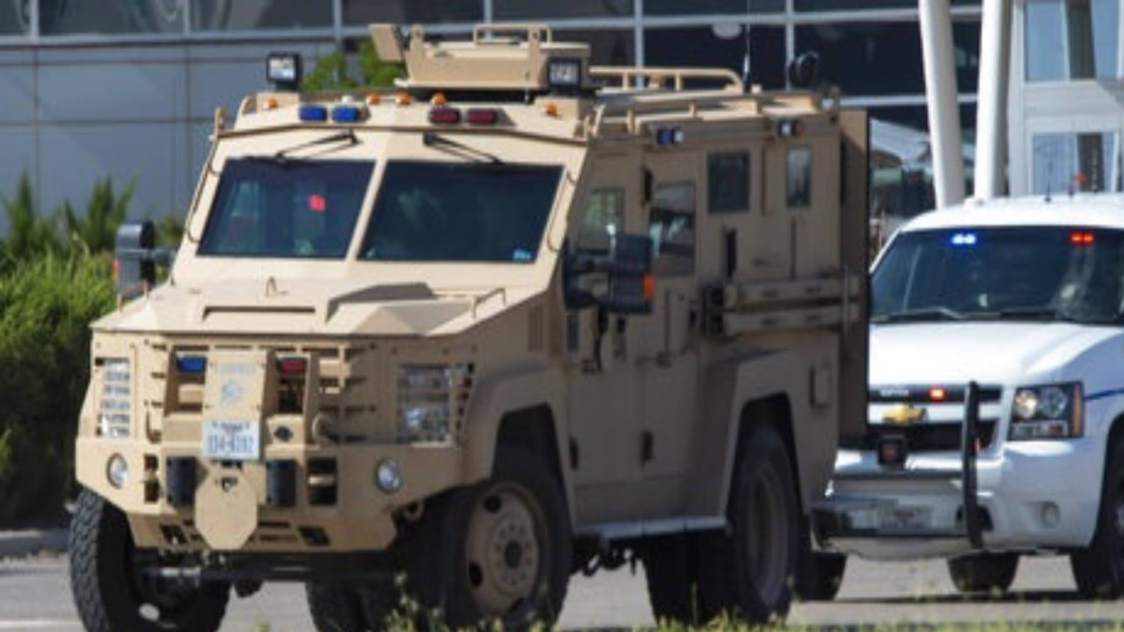 Odessa and Midland police and sheriff's deputies surround the area behind the Cinergy movie theater in Odessa, Texas, after shooting broke out Saturday.